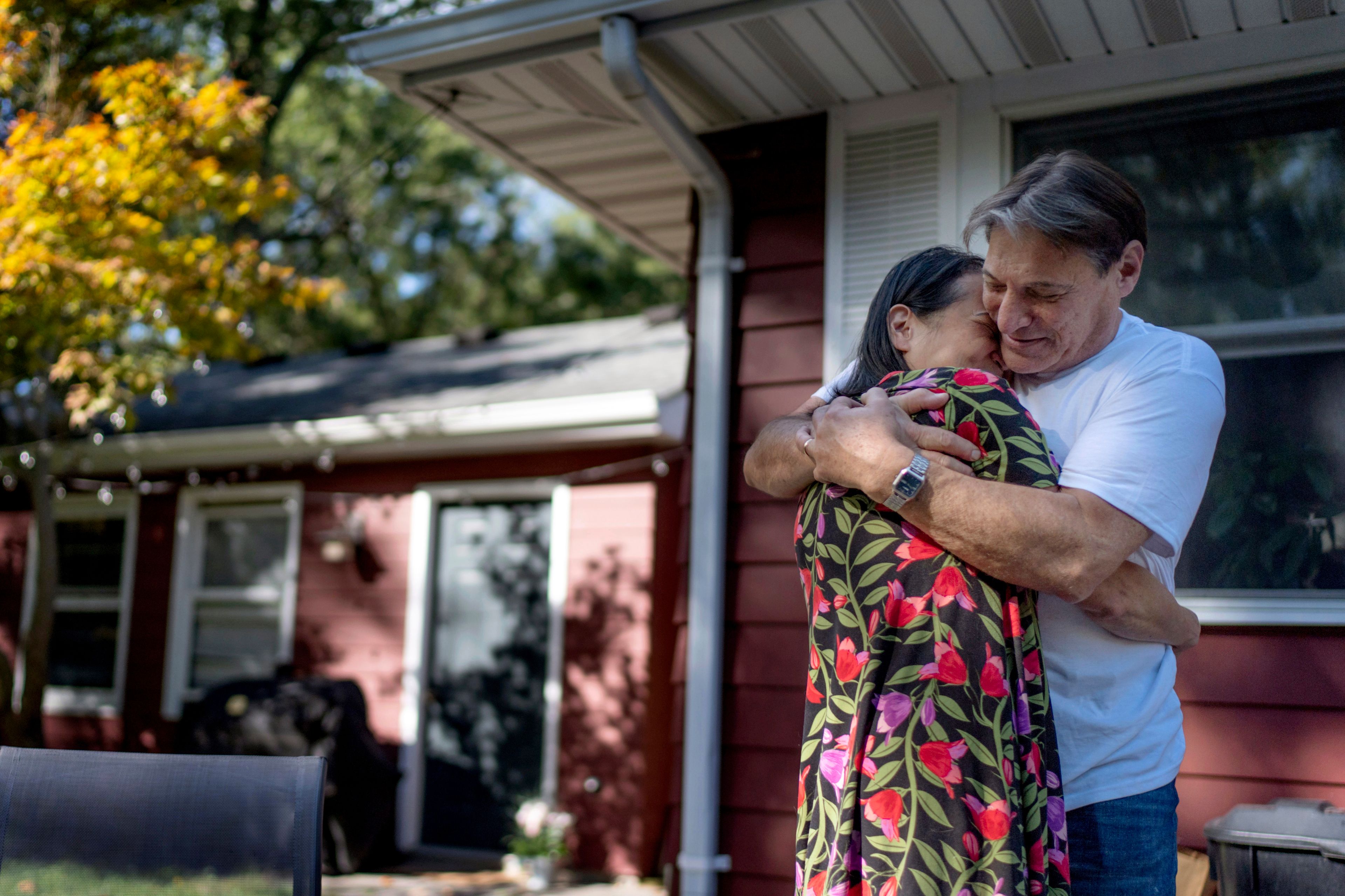 Matt Dzik, right, embraces his wife, Lesley, as he greets her after waking up in Champaign, Ill., Saturday, Sept. 21, 2024. Their need for one another is too great to avoid the discomforts of their many disagreements. "We share the same heart," said Lesley. "I love looking in her eyes and seeing her smile," said Matt. "Why would I want to lose that? (AP Photo/David Goldman)