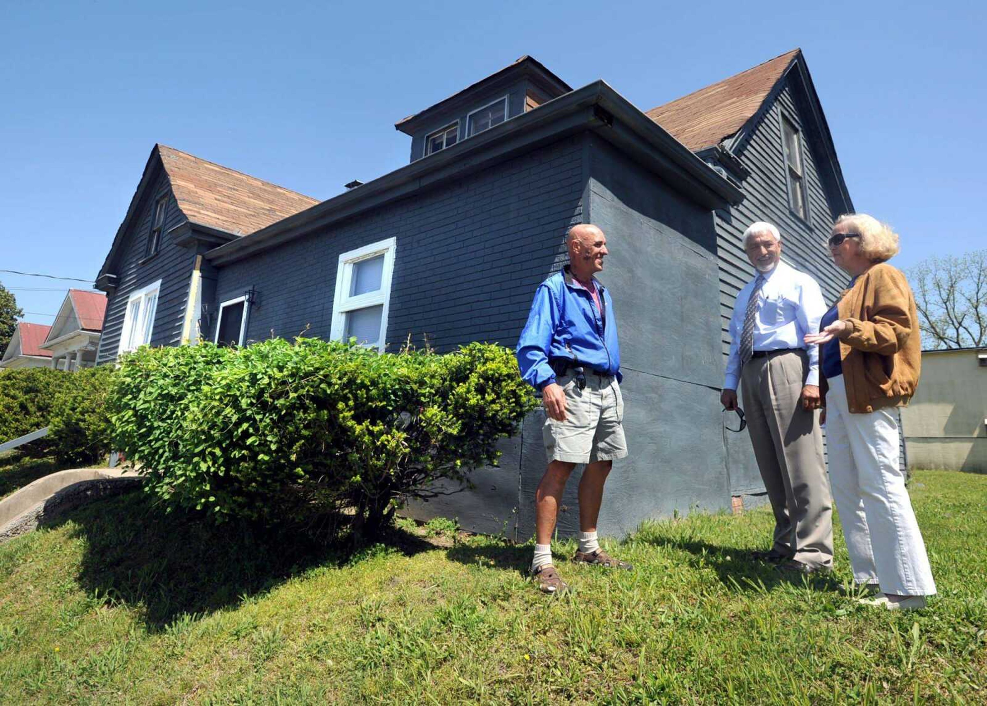 Private investigator Mike Neverett of Sarasota, Fla., left, detective Jim Smith of the Cape Girardeau Police Department and Martha Gill Hamilton outside the house on S. Lorimer Thursday, April 12, 2012 where Hamilton's 2-year-old sister, Elizabeth Ann Gill, disappeared from in 1965. (Laura Simon)