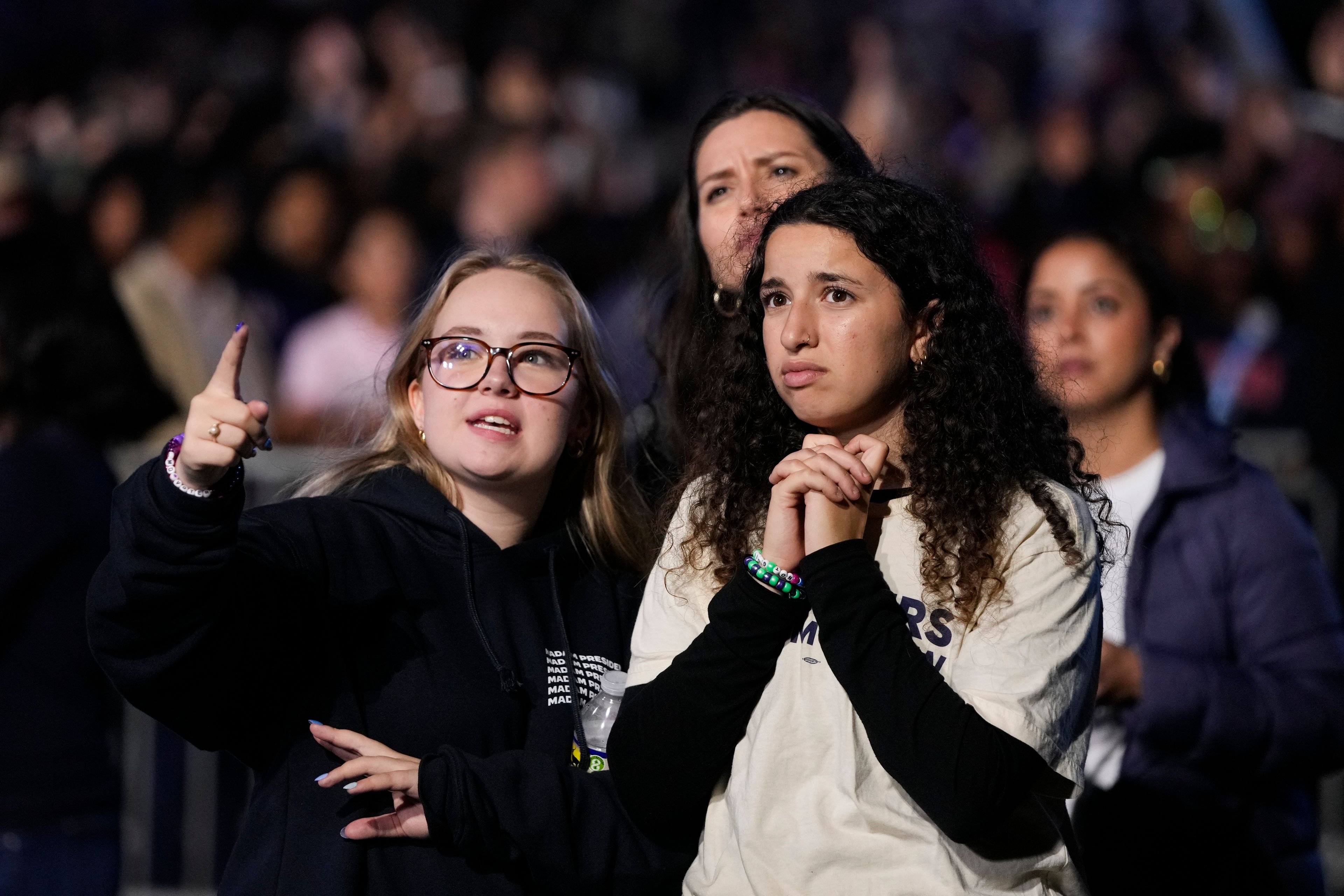 Supporters of Democratic presidential nominee Vice President Kamala Harris look at election results during an election night campaign watch party Tuesday, Nov. 5, 2024, on the campus of Howard University in Washington. (AP Photo/Mark Schiefelbein)