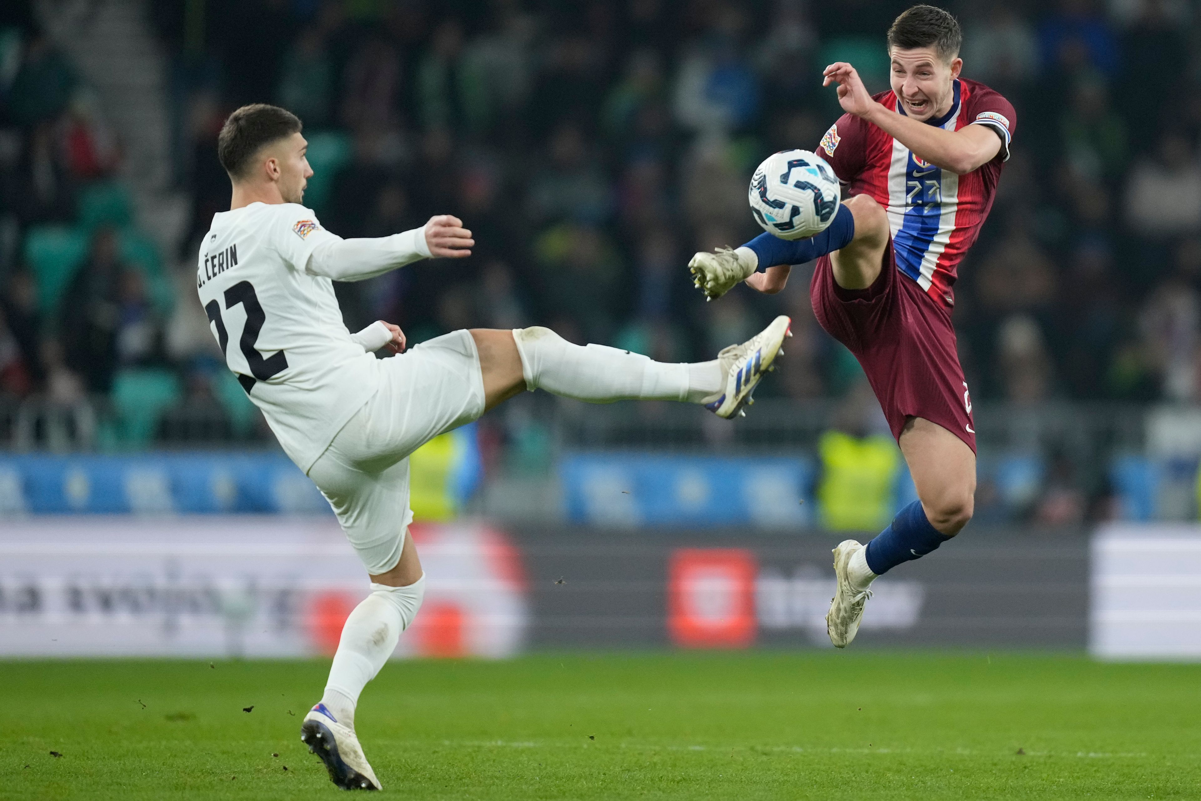 Slovenia's Adam Gnezda Cerin, left, and Norway's Lasse Johnsen go for the ball during the UEFA Nations League soccer match between Slovenia and Norway at Stozice stadium in Ljubljana, Slovenia, Thursday, Nov. 14, 2024. (AP Photo/Darko Bandic)