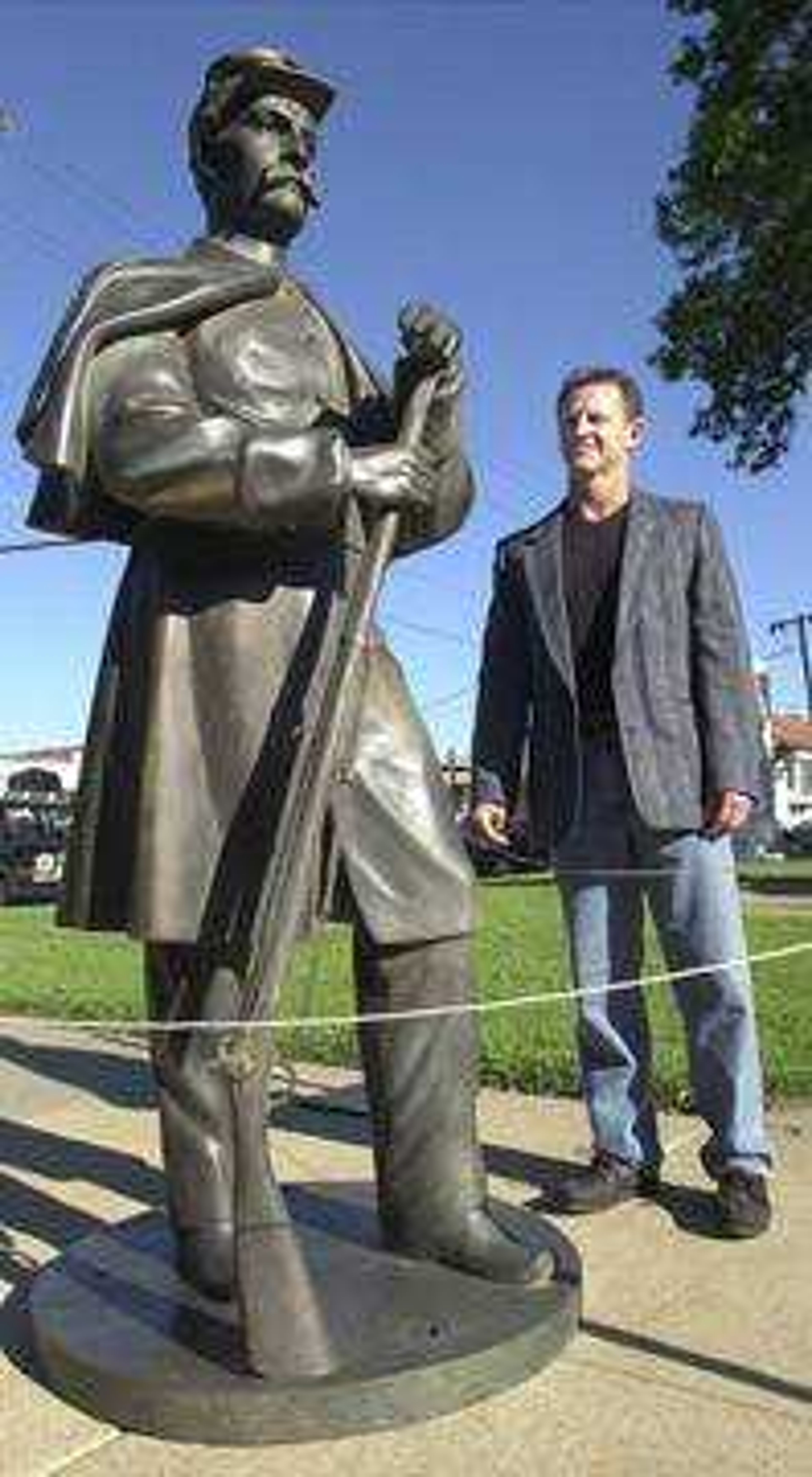 Dexter artist Alan Gibson stood next to the Civil War soldier statue that he made with polyester resin and bronze to replace the cast iron statue atop the fountain at Common Pleas Courthouse Park in Cape Girardeau.