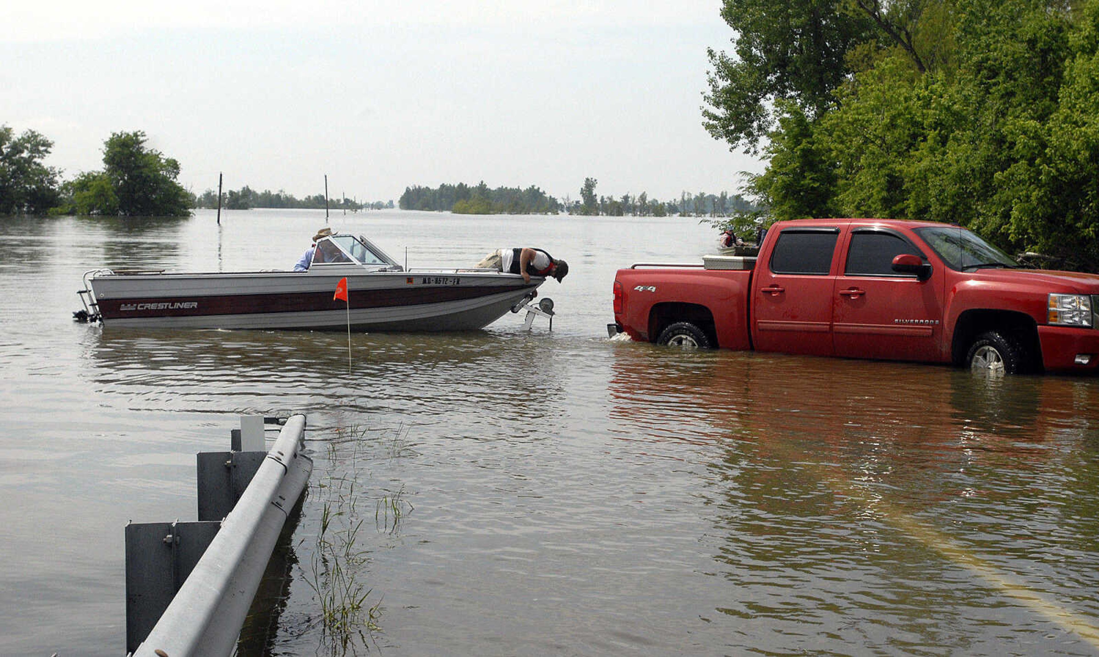 LAURA SIMON~lsimon@semissourian.com
Land owners launch their boat from Highway 102 Monday, May 9, 2011 to check on their property in the floodway in Mississippi County.