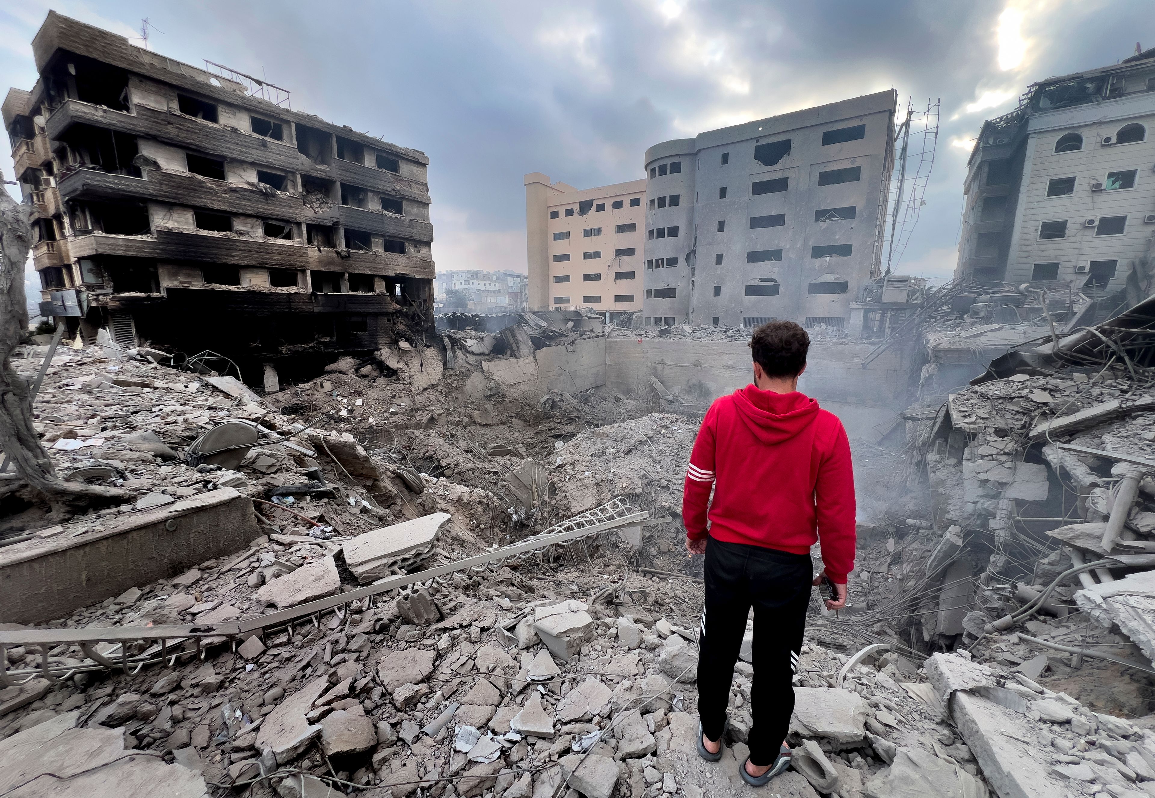 A man looks at destroyed buildings hit by Israeli airstrikes in Dahiyeh, Beirut, Lebanon, Monday, Oct. 7, 2024. (AP Photo/Hussein Malla,)