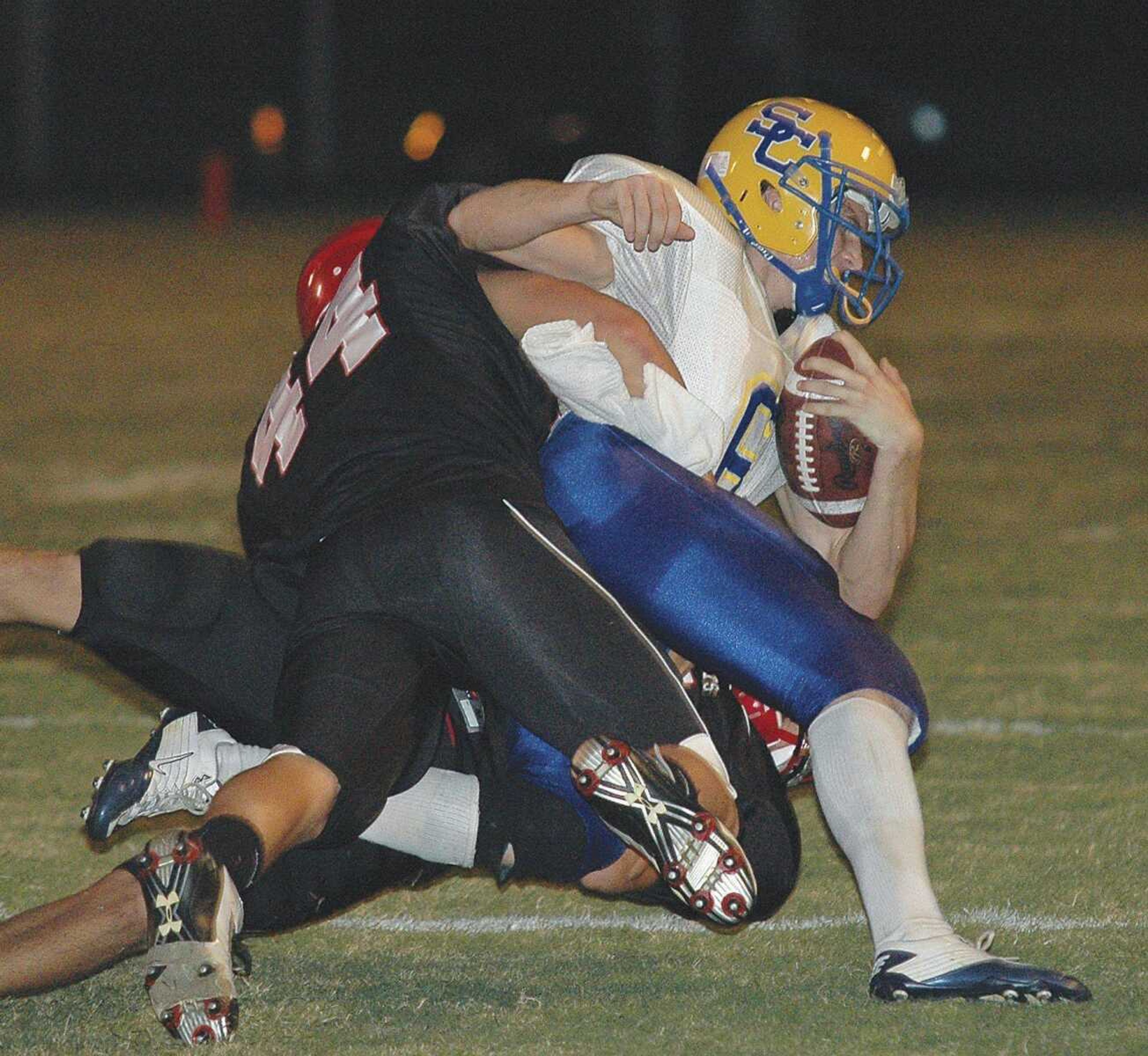 Scott City junior Austin Atchley gets tackled by Dexter defenders during Friday's game in Dexter, Mo. (JERRY JARRELL ~ Dexter Daily Statesman)