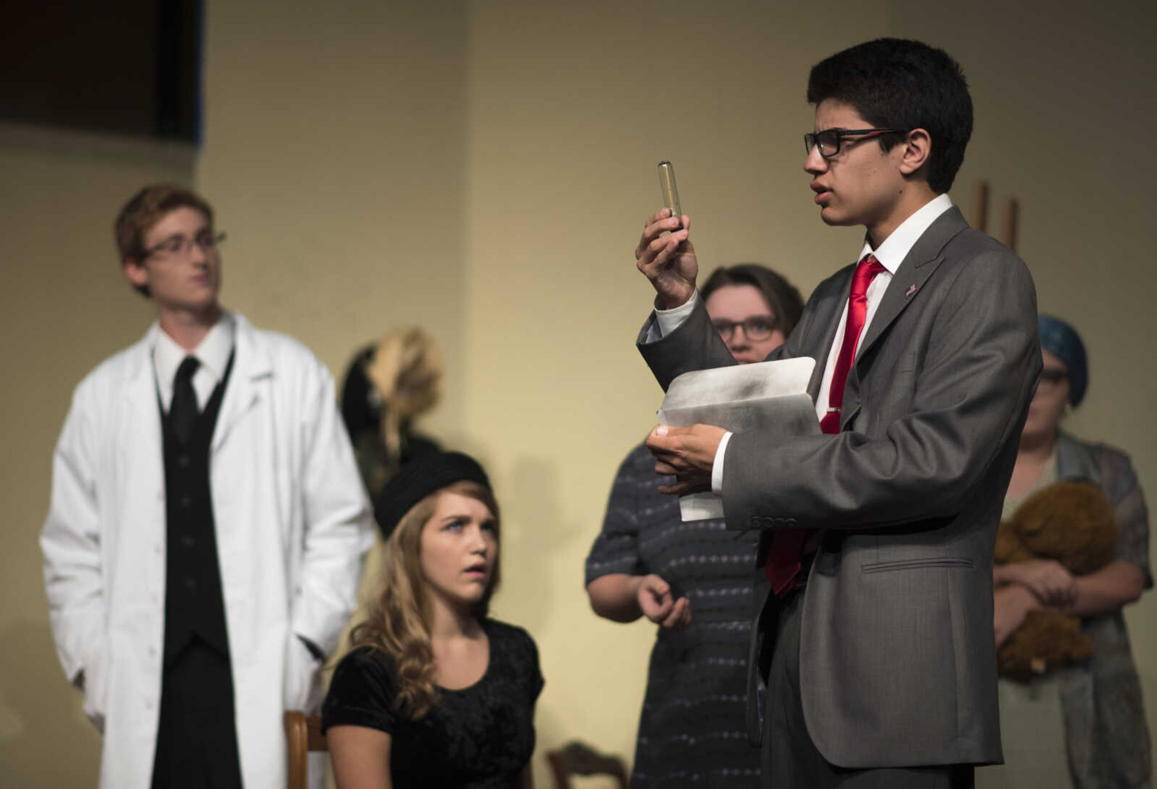 Titus, played by Kade Groh, inspects a box of radio tubes during a scene in a dress rehearsal for Jackson's fall play, "The Curious Savage" Oct. 10, 2017 at Jackson High School.