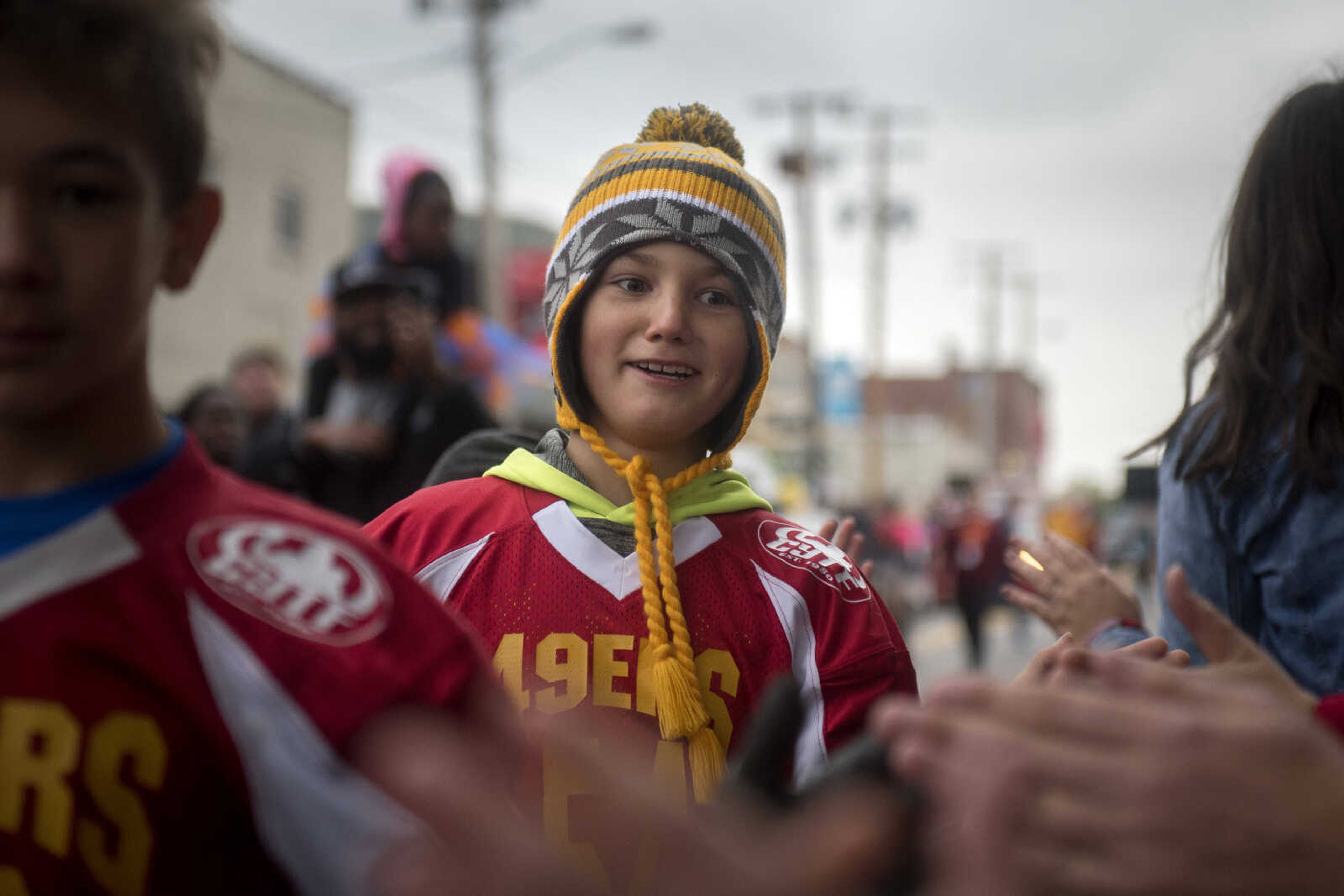 Young athletes get high-fives from a line of parade attendees during the Southeast Missouri State University homecoming parade Saturday, Oct. 13, 2018.