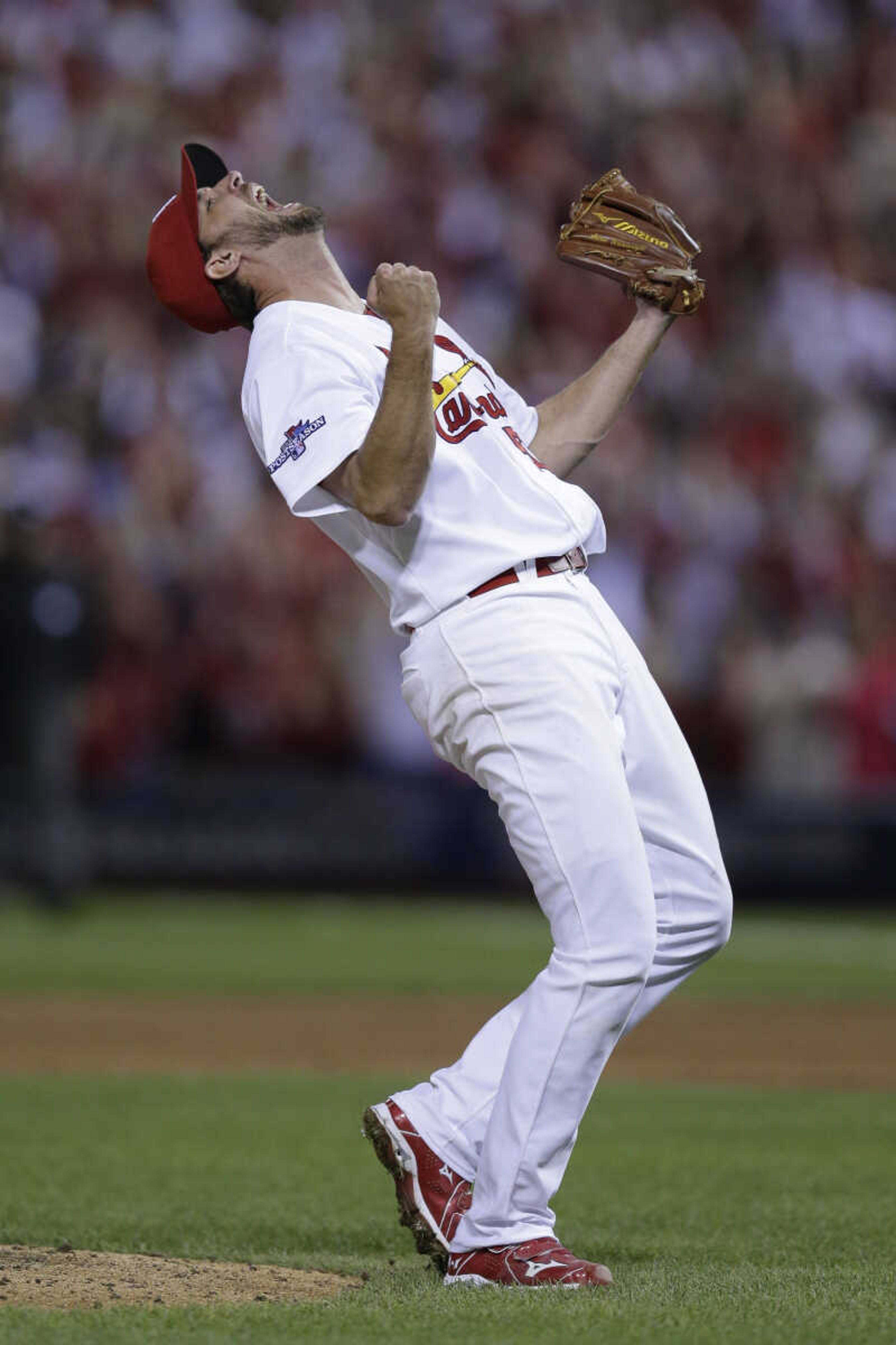 St. Louis Cardinals pitcher Adam Wainwright celebrates after striking out Pittsburgh Pirates' Pedro Alvarez for the final out of Game 5 of a National League baseball division series, Wednesday, Oct. 9, 2013, in St. Louis. The Cardinals won 6-1, and advanced to the NL championship series against the Los Angeles Dodgers. (AP Photo/Charlie Riedel)