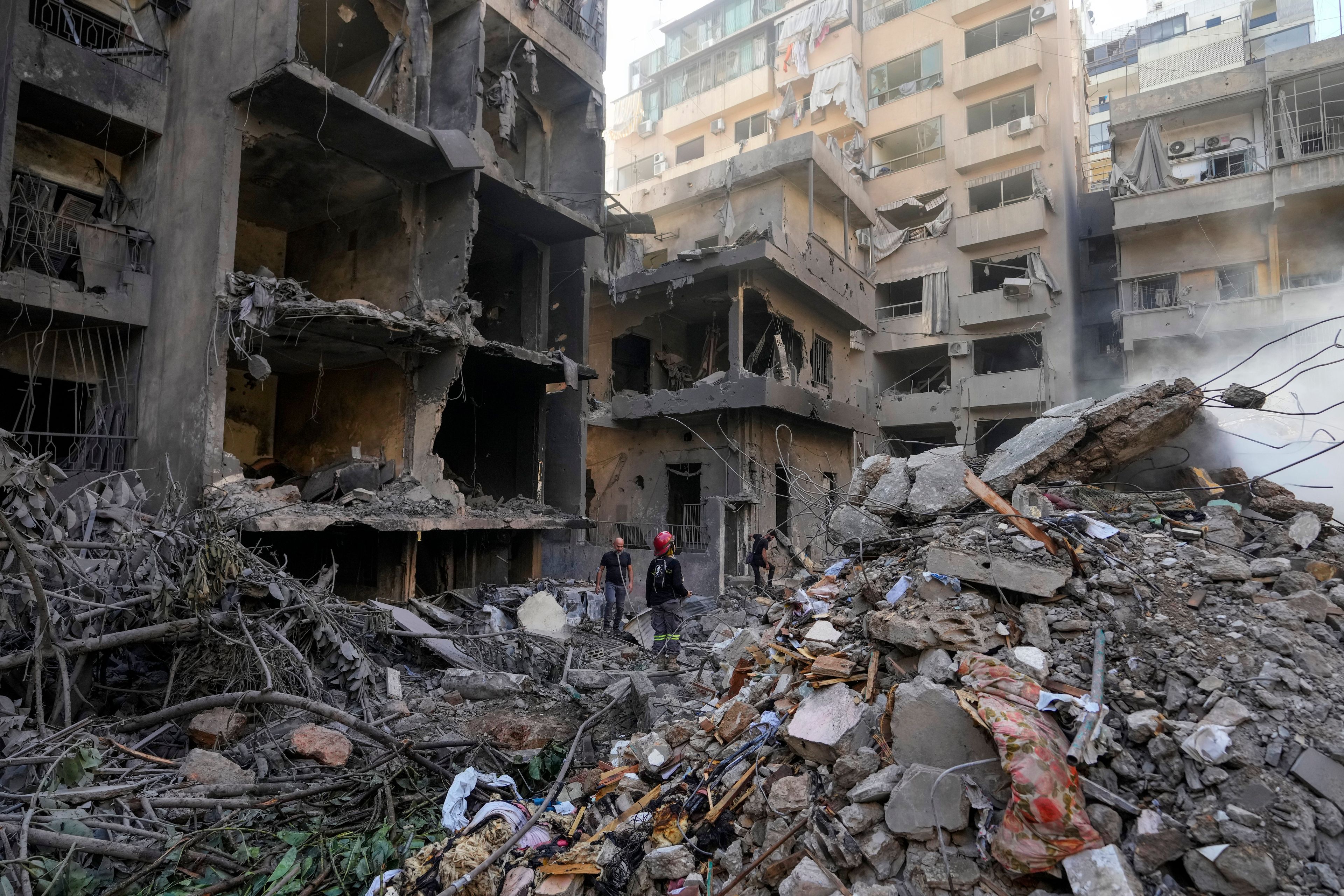 Rescue workers search for victims at the site of Thursday's Israeli airstrike in Beirut, Lebanon, Friday, Oct. 11, 2024. (AP Photo/Hassan Ammar)