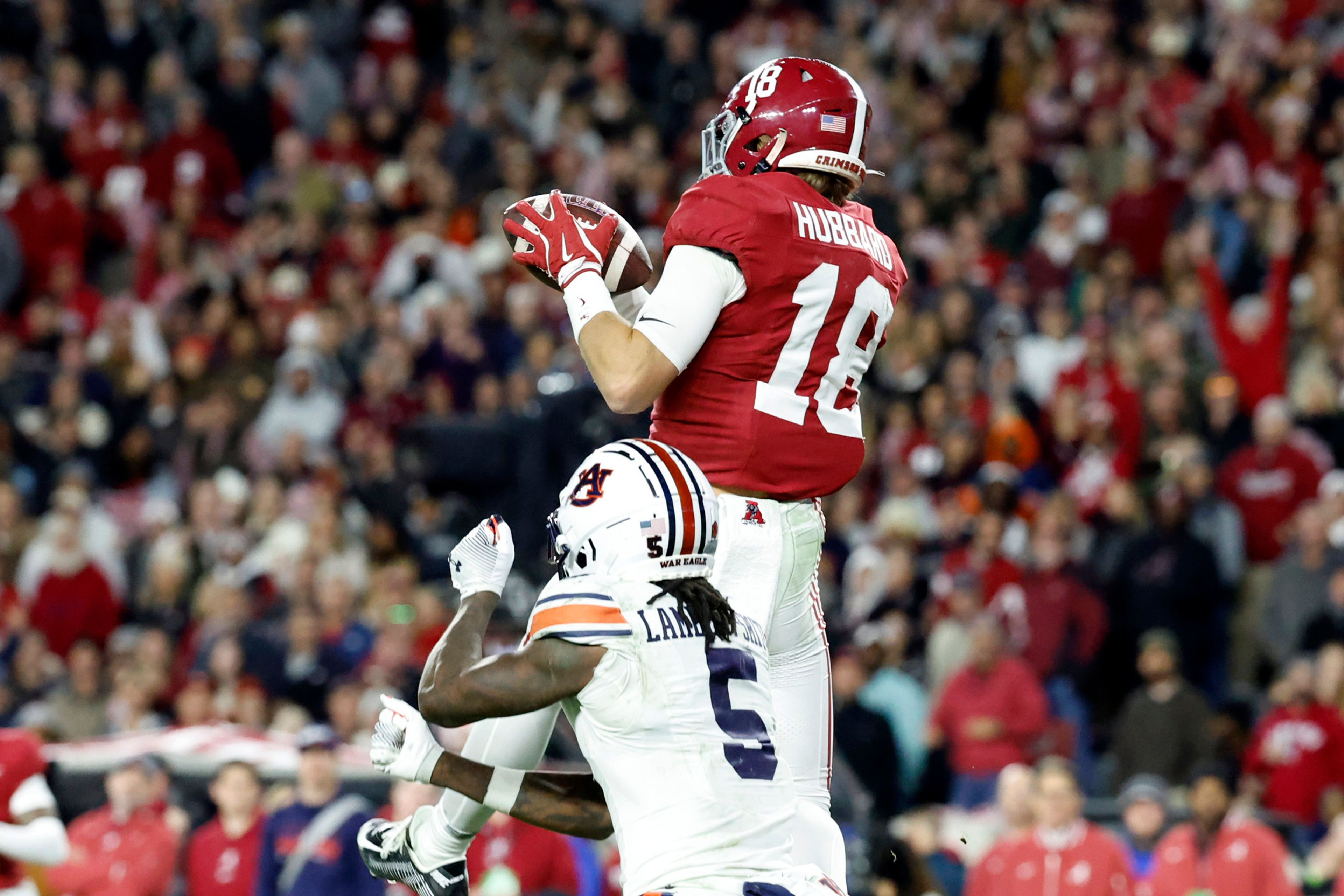 Alabama defensive back Bray Hubbard (18) intercepts a pass intended for Auburn wide receiver KeAndre Lambert-Smith (5) during the second half of an NCAA college football game, Saturday, Nov. 30, 2024, in Tuscaloosa, Ala. (AP Photo/Butch Dill)