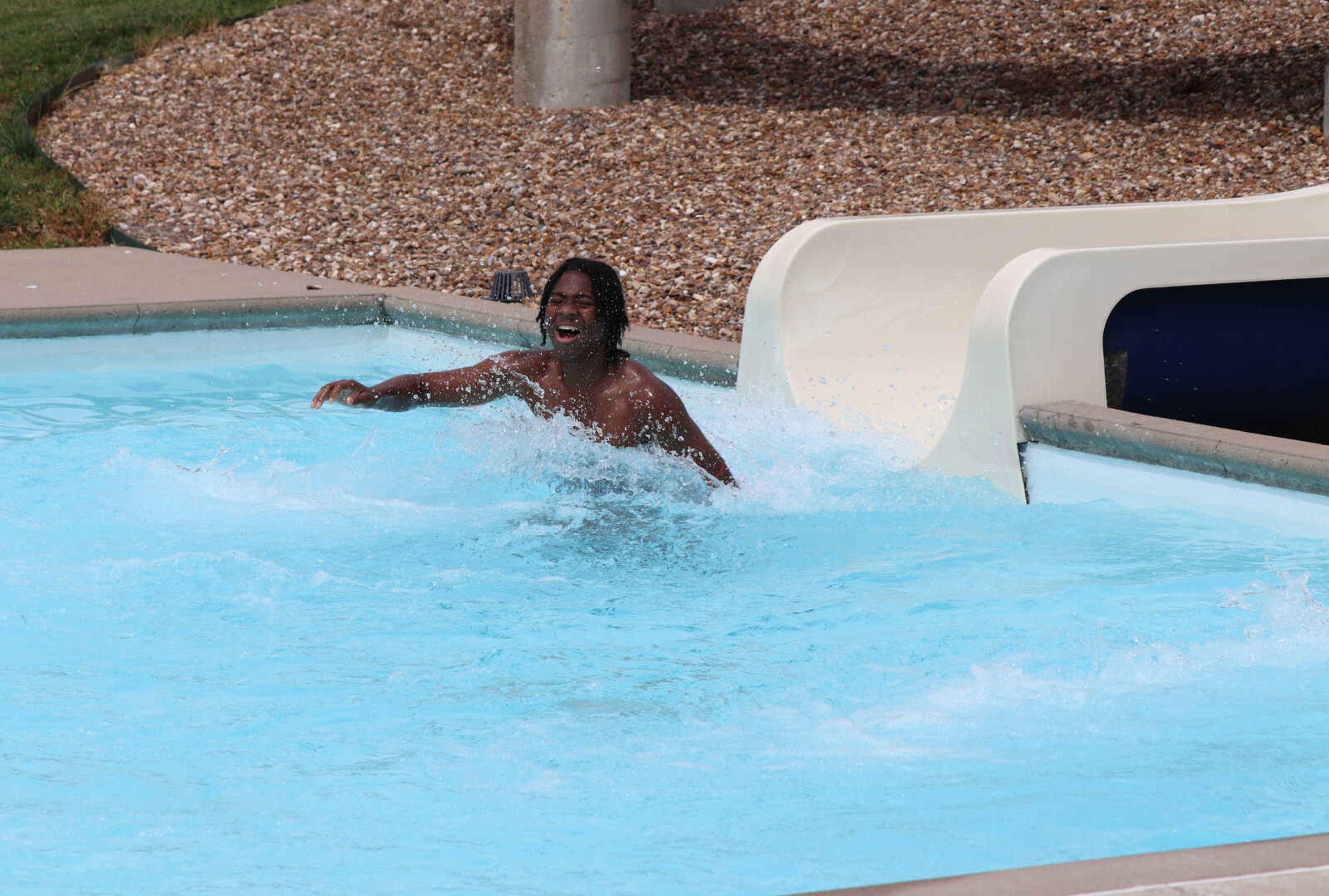 Linard Thomas crashes into the water after making his way down the slide at Cape Splash on Thursday.