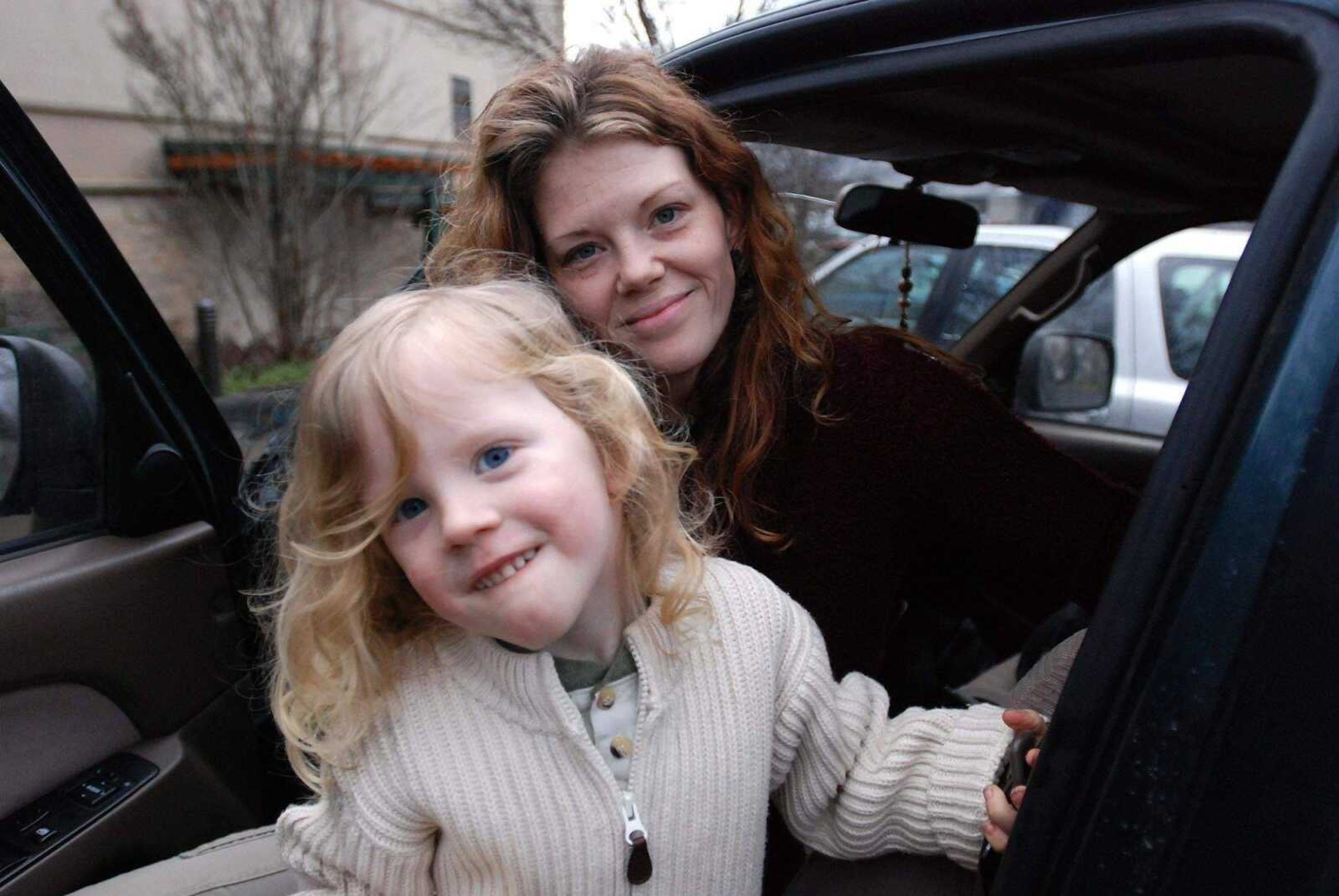 JEFF BARNARD ~ Associated Press<br>Tyre Dawn and her son, Lukyan, 4, are seen Tuesday outside an organic food store in Ashland, Ore. Locals will get $50 apiece today to talk about their worries over the risks of childhood shots. This town doesn't trust the government.