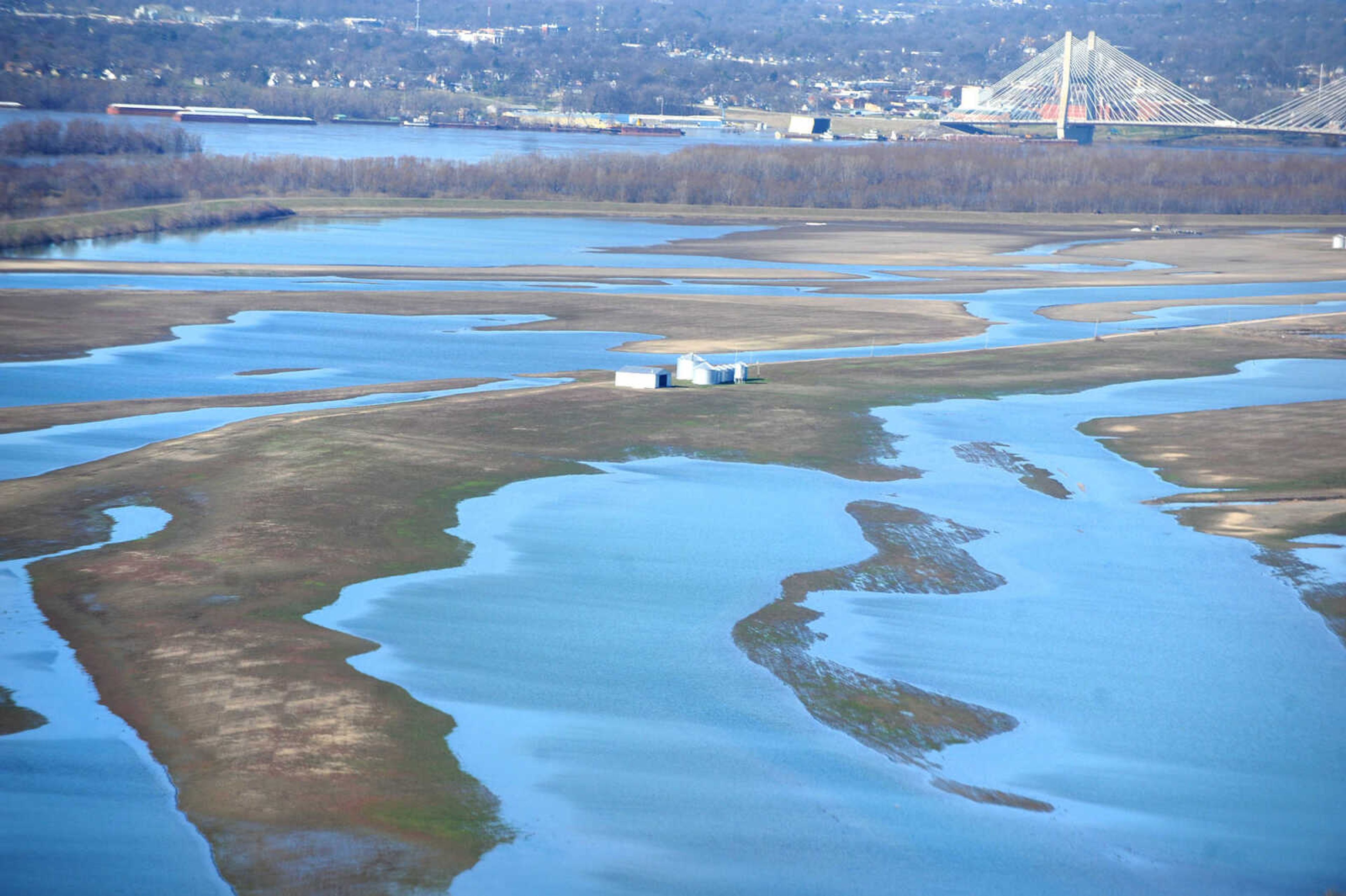 LAURA SIMON ~ lsimon@semissourian.com

The swollen Mississippi River is seen flowing under the Bill Emerson Memorial Bridge in Cape Girardeau, Saturday, Jan. 2, 2016.