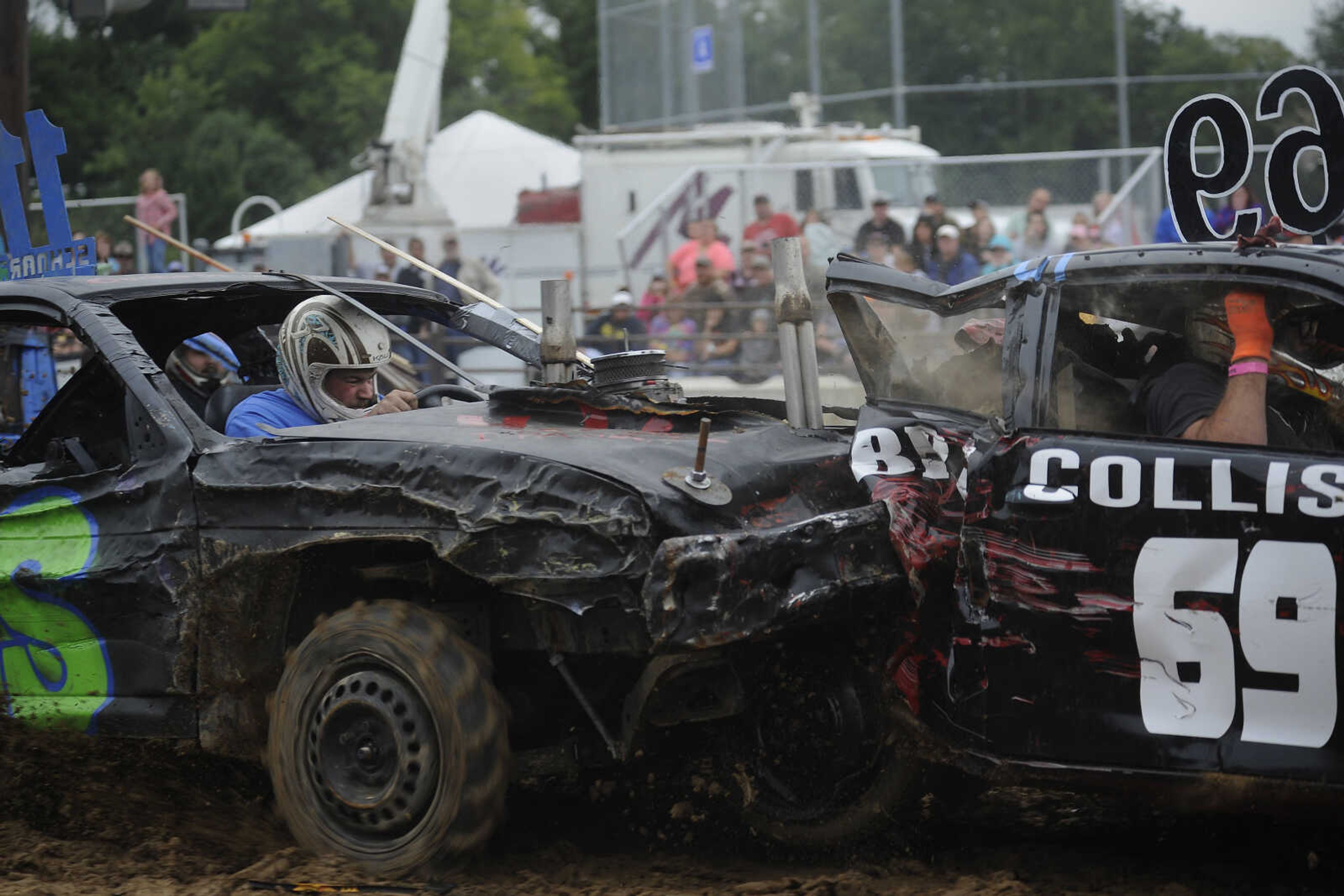 A driver rams another car, putting it out of commission, during the demolition derby Sunday.