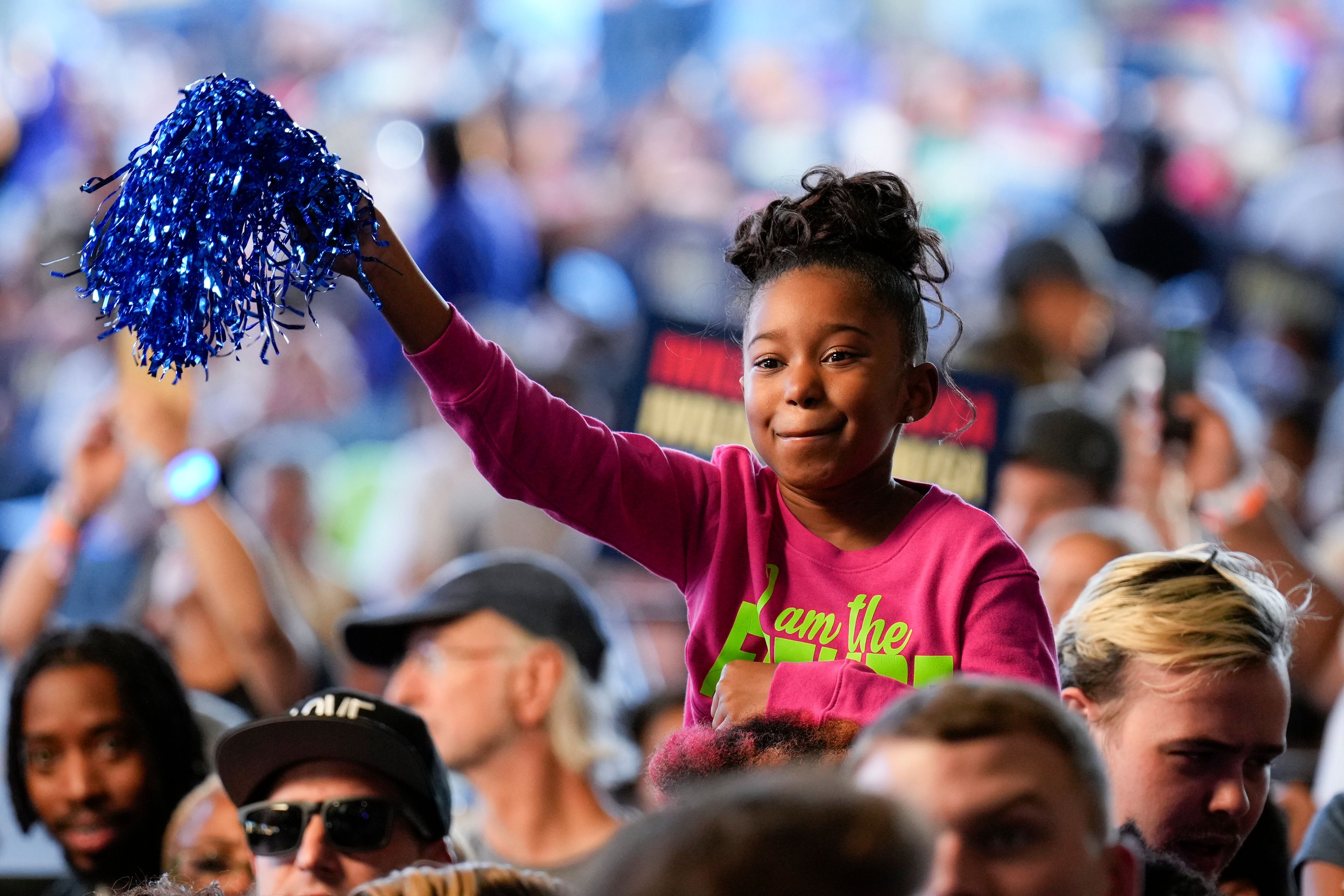 A child waves a blue pom pom during a campaign event for Democratic presidential nominee Vice President Kamala Harris speaks at Lakewood Amphitheatre, Saturday, Oct. 19, 2024, in Atlanta. (AP Photo/Jacquelyn Martin)