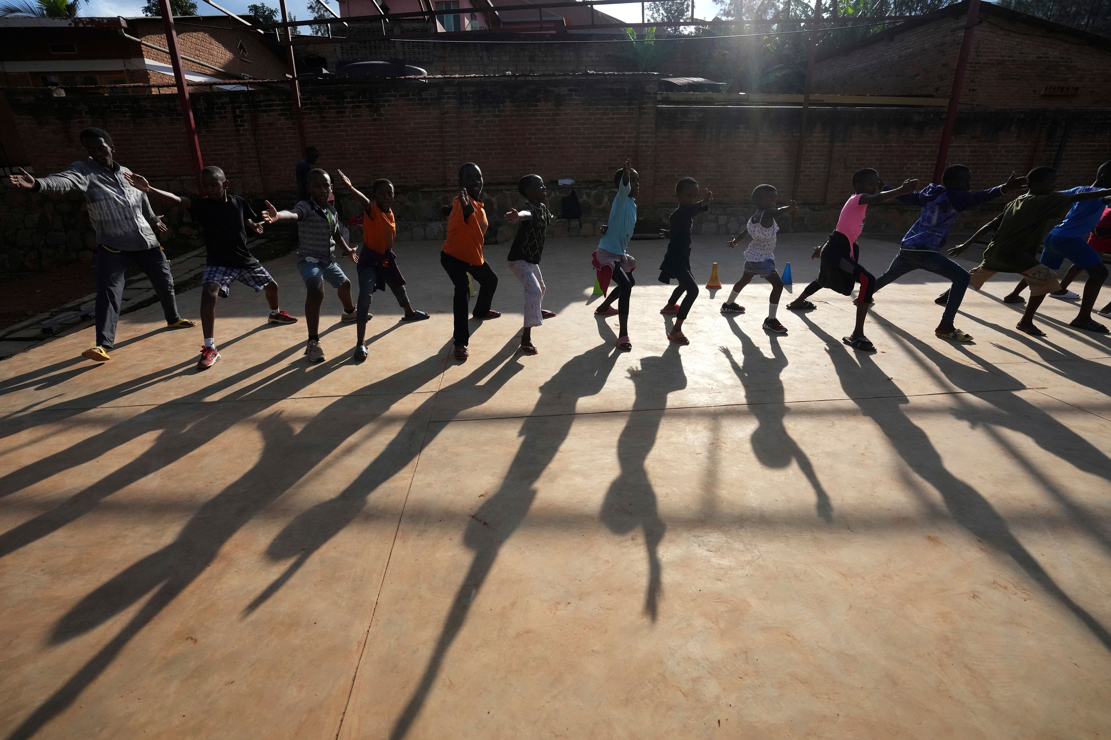 FILE -Children practise fencing game, on the outskirts of Kigali, Rwanda, April 4, 2024. (AP Photo/Brian Inganga, File)