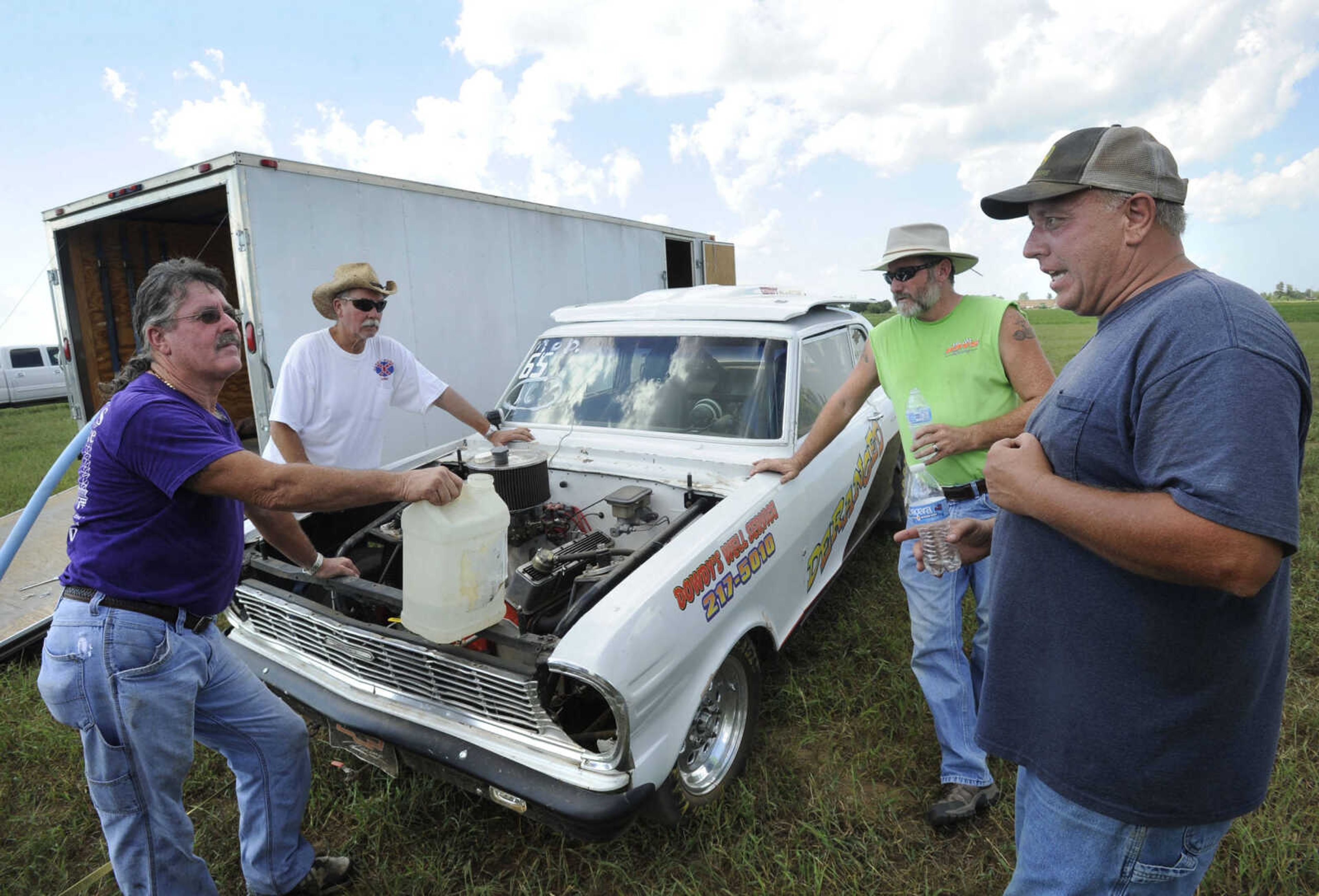 FRED LYNCH ~ flynch@semissourian.com
Jason Owens, right, discusses an upcoming race with driver Tony Dowdy, left, Randy Dowdy and Jason Hays on Saturday, Aug. 19, 2017 at Missouri Dirt Motorsports in Sikeston, Missouri.