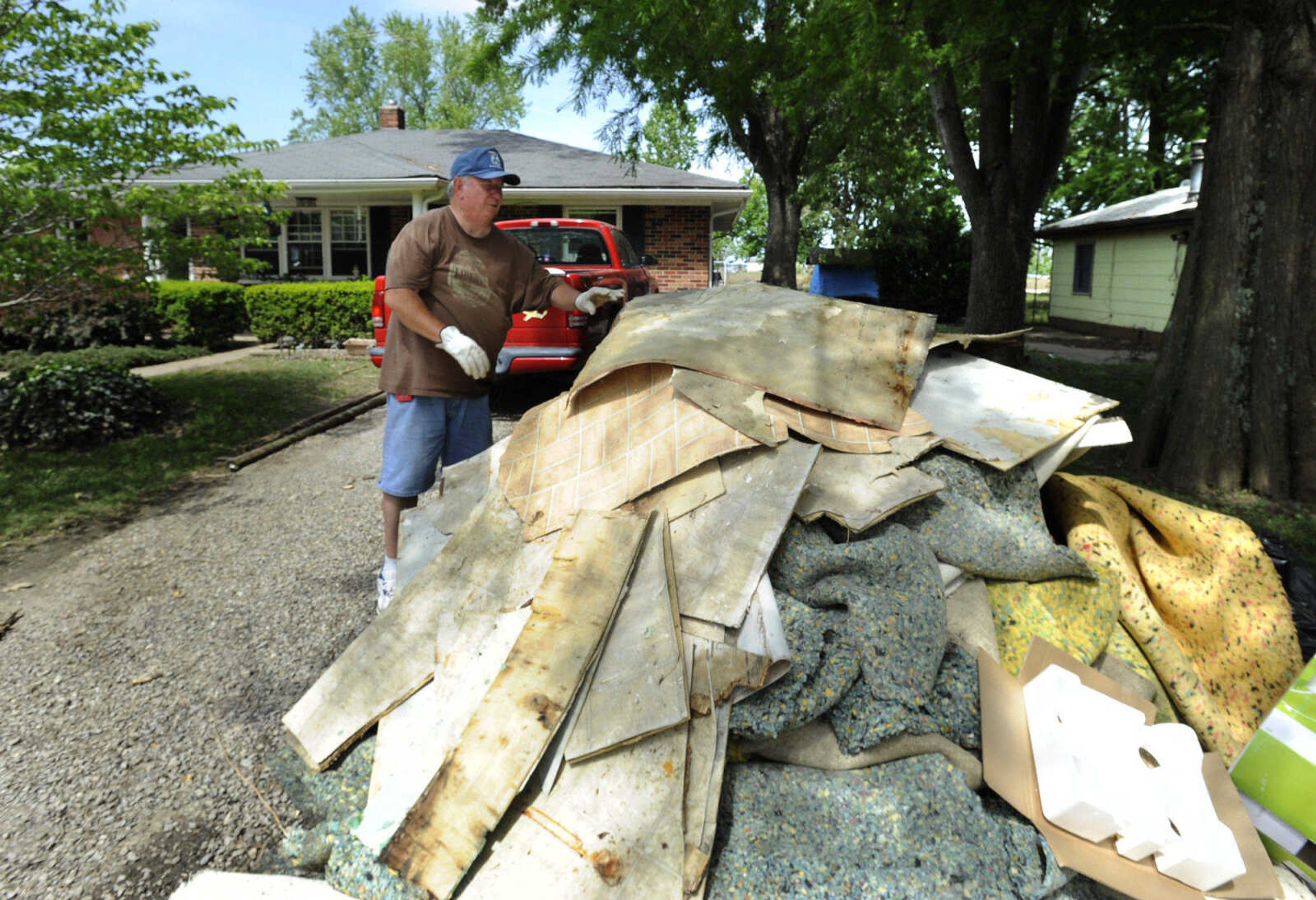 FRED LYNCH ~ flynch@semissourian.com
Jim Melton removes damaged carpet and flooring from his house Thursday, May 12, 2011 after floodwaters receded from Horseshoe Lake near Olive Branch, Ill. Melton's house is located across the street from the lake.