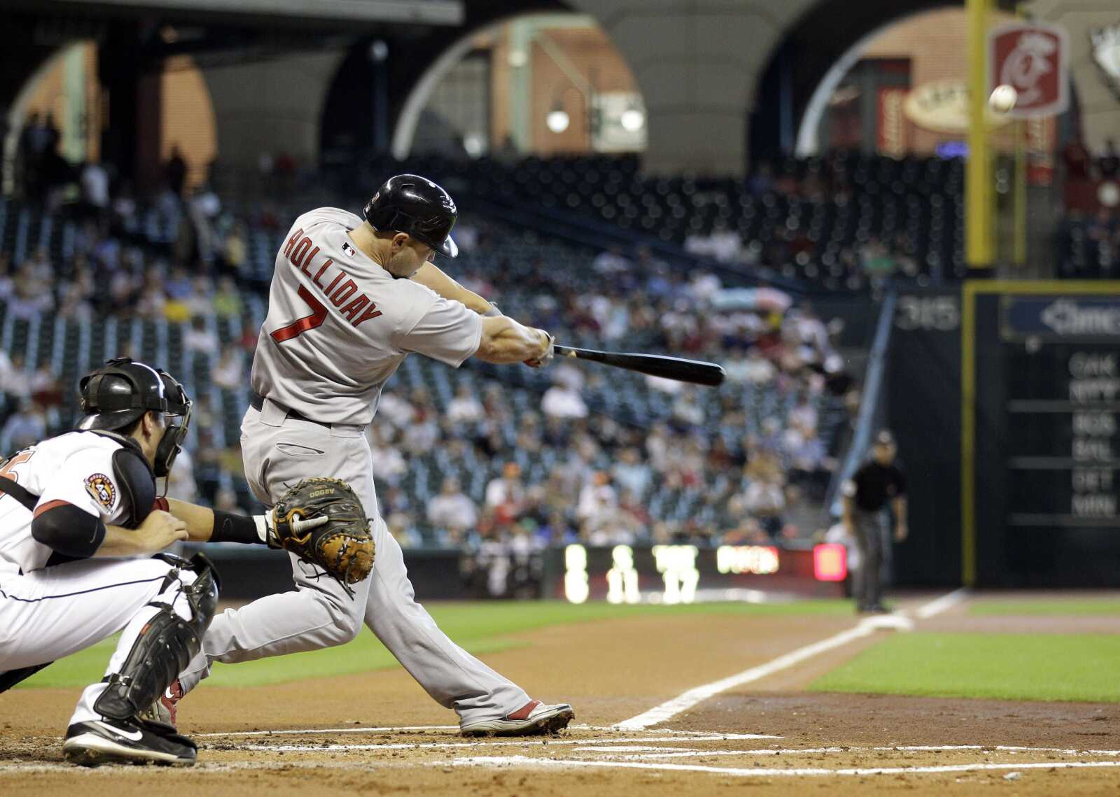 Cardinals outfielder Matt Holliday hits a two-run home run during the first inning Wednesday in Houston. (DAVID PHILLIP ~ Associated Press)