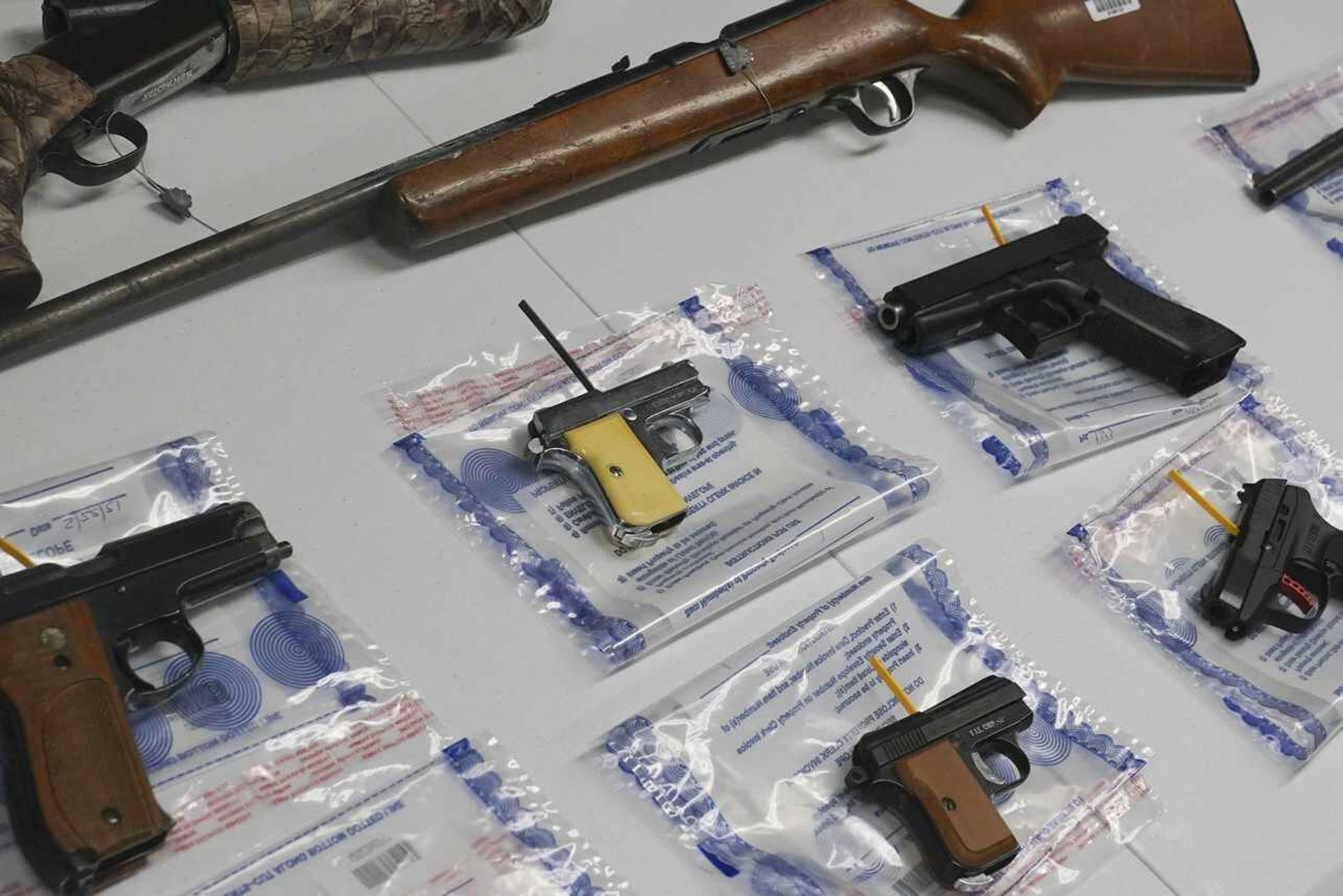 A collection of illegal guns is displayed during a gun buyback event May 22, 2021, in the Brooklyn borough of New York. Individuals received pre-paid card payments of $25 up to $250 for firearms -- with a bonus iPad for certain handguns or assault rifles, at the no-questions-asked event, co-sponsored by state and county attorney generals and the NYPD. According to a study published by JAMA Network Open on Tuesday, Nov. 29, the U.S. gun death rate in 2021 hit its highest mark in nearly three decades, and the rate among women has been growing faster than that of men.