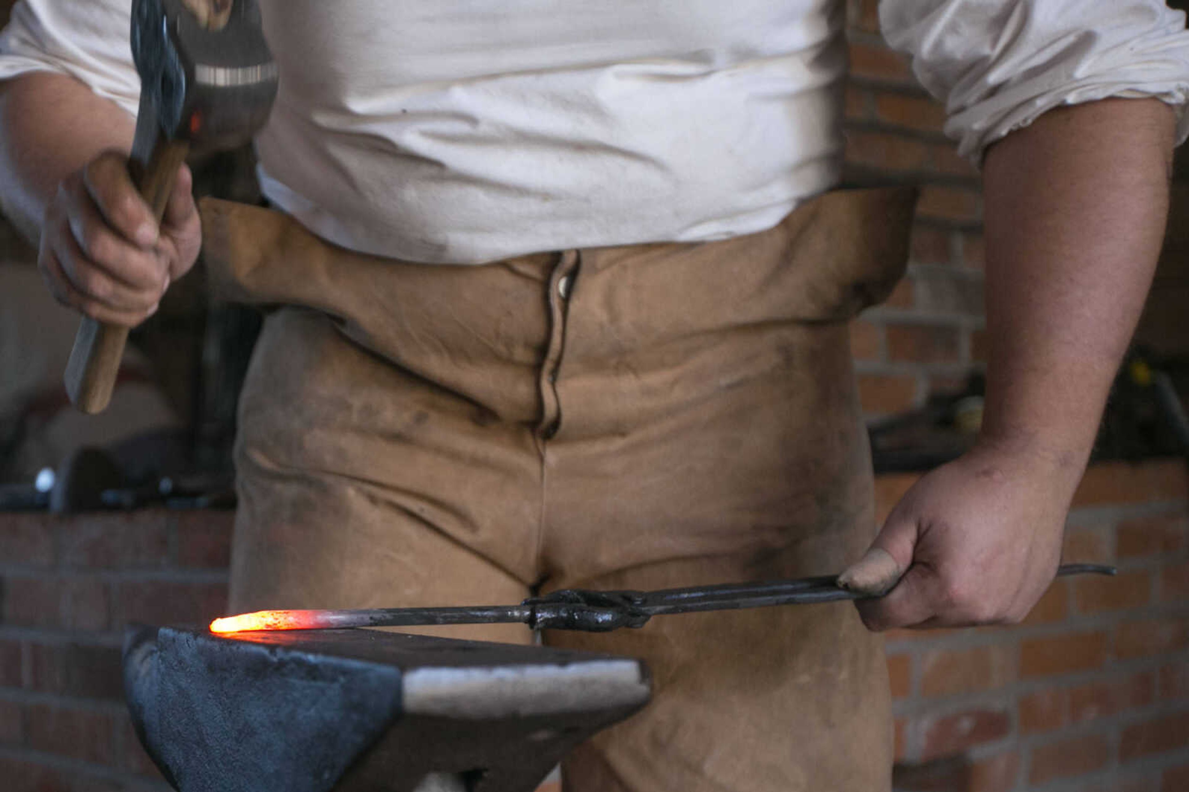 GLENN LANDBERG ~ glandberg@semissourian.com

Ian Wille uses a hammer to fashion a square nail in the blacksmith demonstration area of the Fall Festival at the Saxon Lutheran Memorial in Frohna, Missouri, Saturday, Oct. 10, 2015.