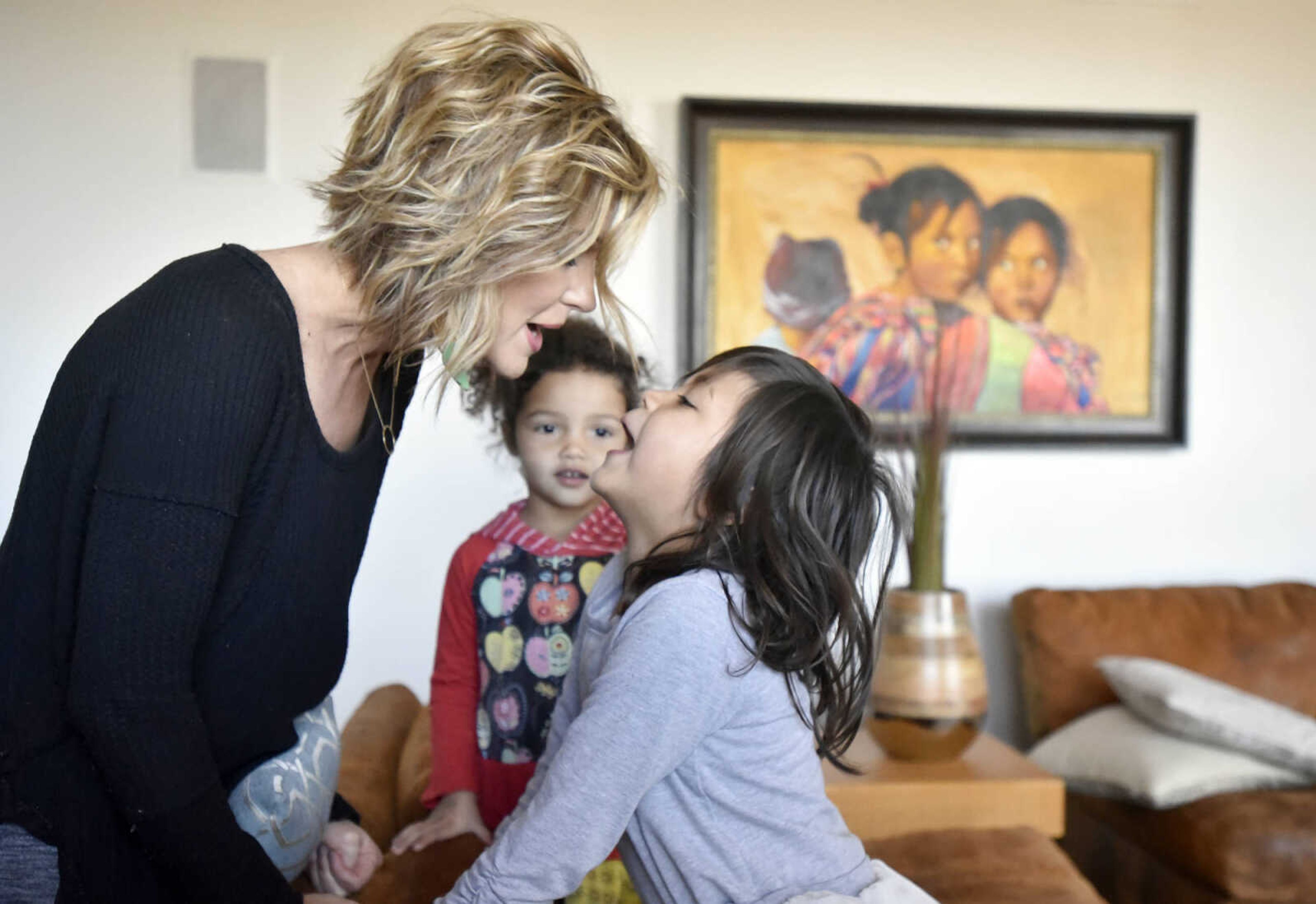 Ari Becking, 5, goes "muah" after getting a kiss from her mother, Chantelle on Saturday, Jan. 28, 2017, at the Becking's Cape Girardeau home. Ari and her sister Dolly, 3, were trying to transfer their mother's lipstick on them.