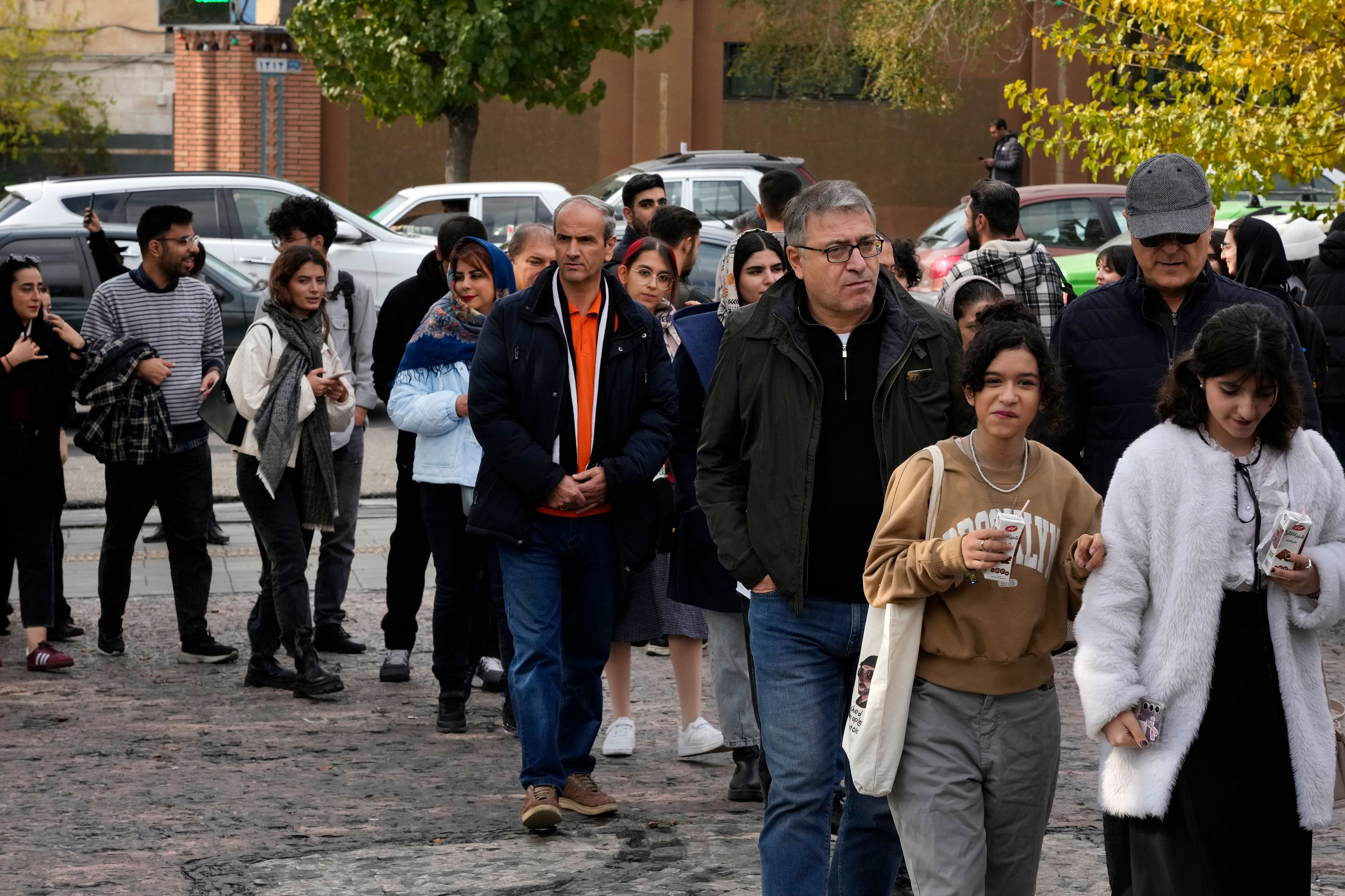 Iranians line up to visit an exhibition titled Eye to Eye which showcases over 120 works by modern world artists as well as Iranian painters at Tehran Museum of Contemporary Art, in Tehran, Thursday, Nov. 21, 2024. (AP Photo/Vahid Salemi)