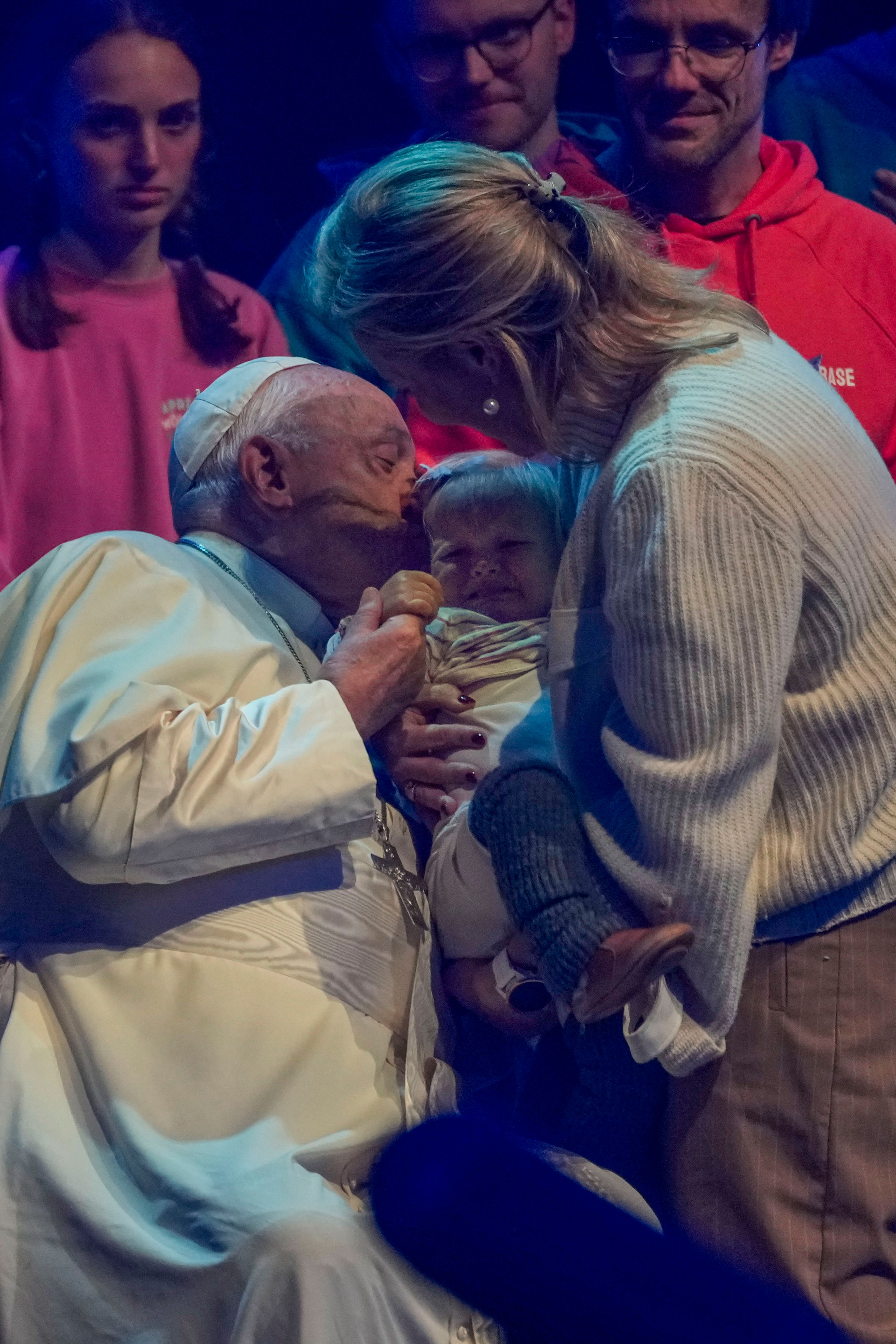 Pope Francis kisses a child during the Hope Happening youth festival at the Brussels Expo, Belgium, Saturday, Sept. 28, 2024, on the third day of his four-day visit to Luxembourg and Belgium. (AP Photo/Andrew Medichini)