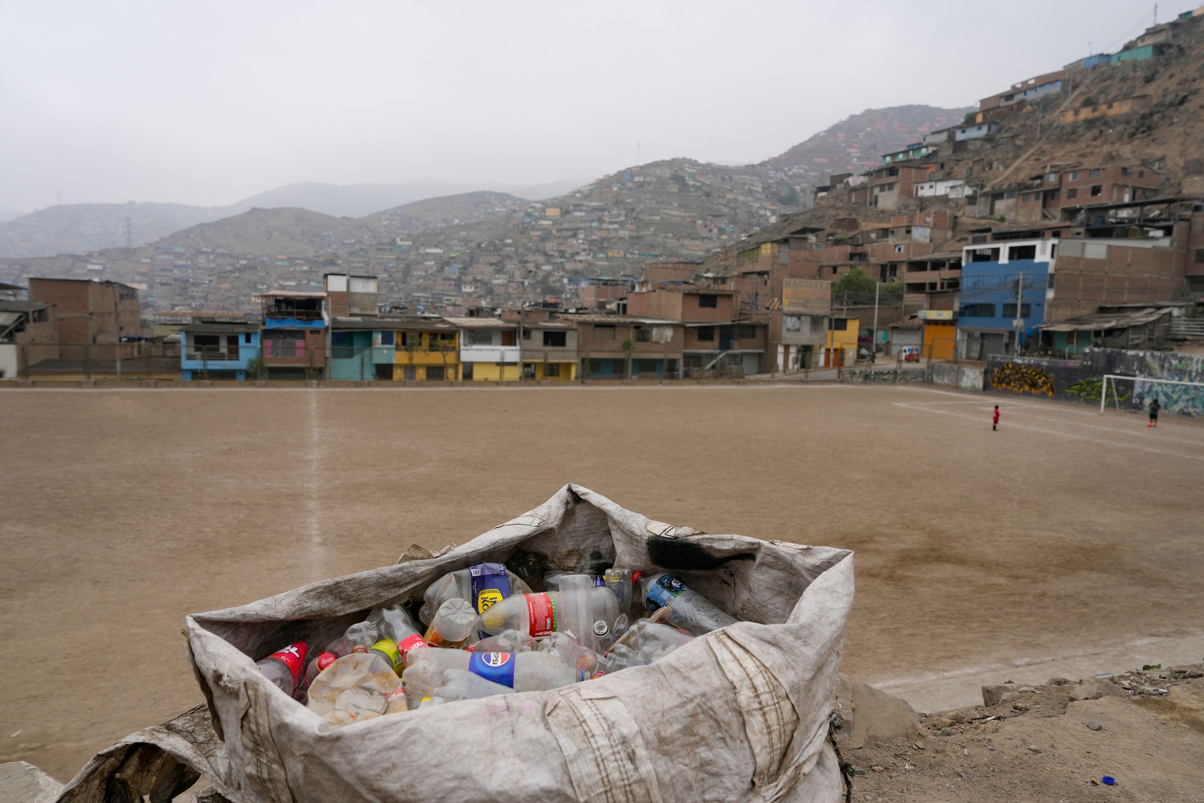 Plastic bottles collected from garbage dumps and streets by recycler Jorge Tejada fill a bag, in Lima, Peru, Tuesday, Nov. 26, 2024. (AP Photo/Guadalupe Pardo)