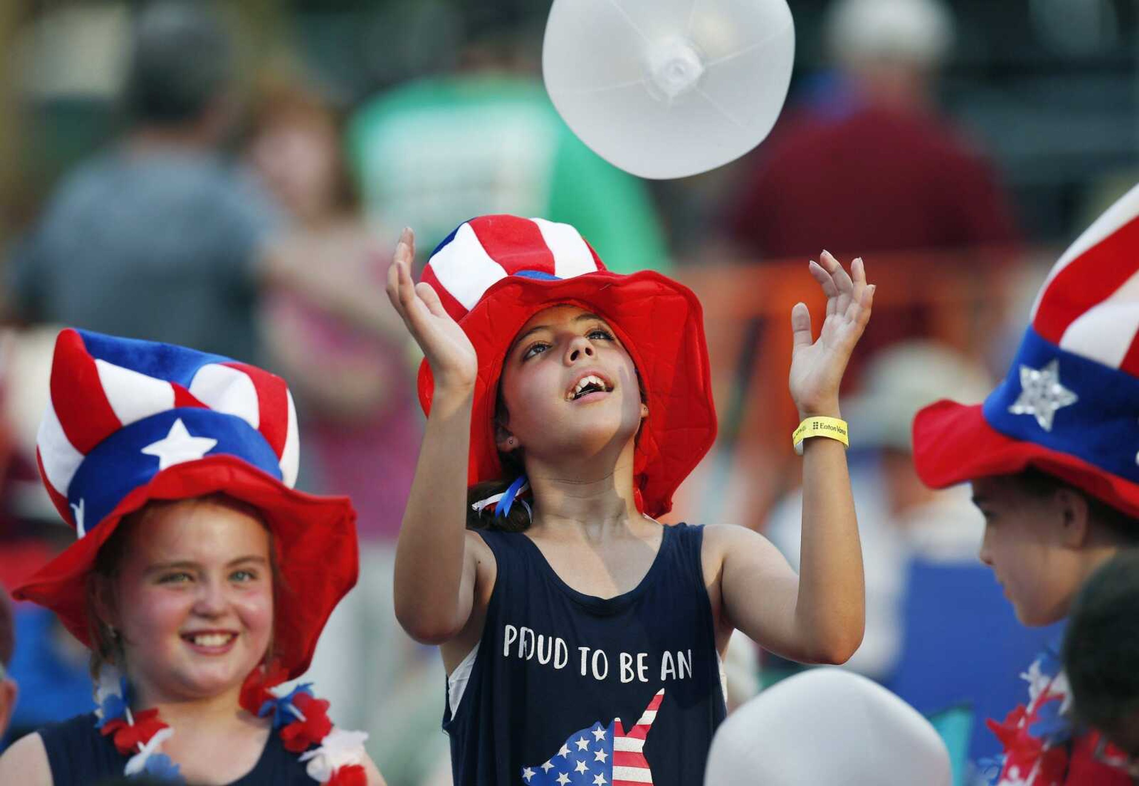 Maddie Scaletta, center, waits with friends for the start of rehearsals for the Boston Pops Fireworks Spectacular in Boston.