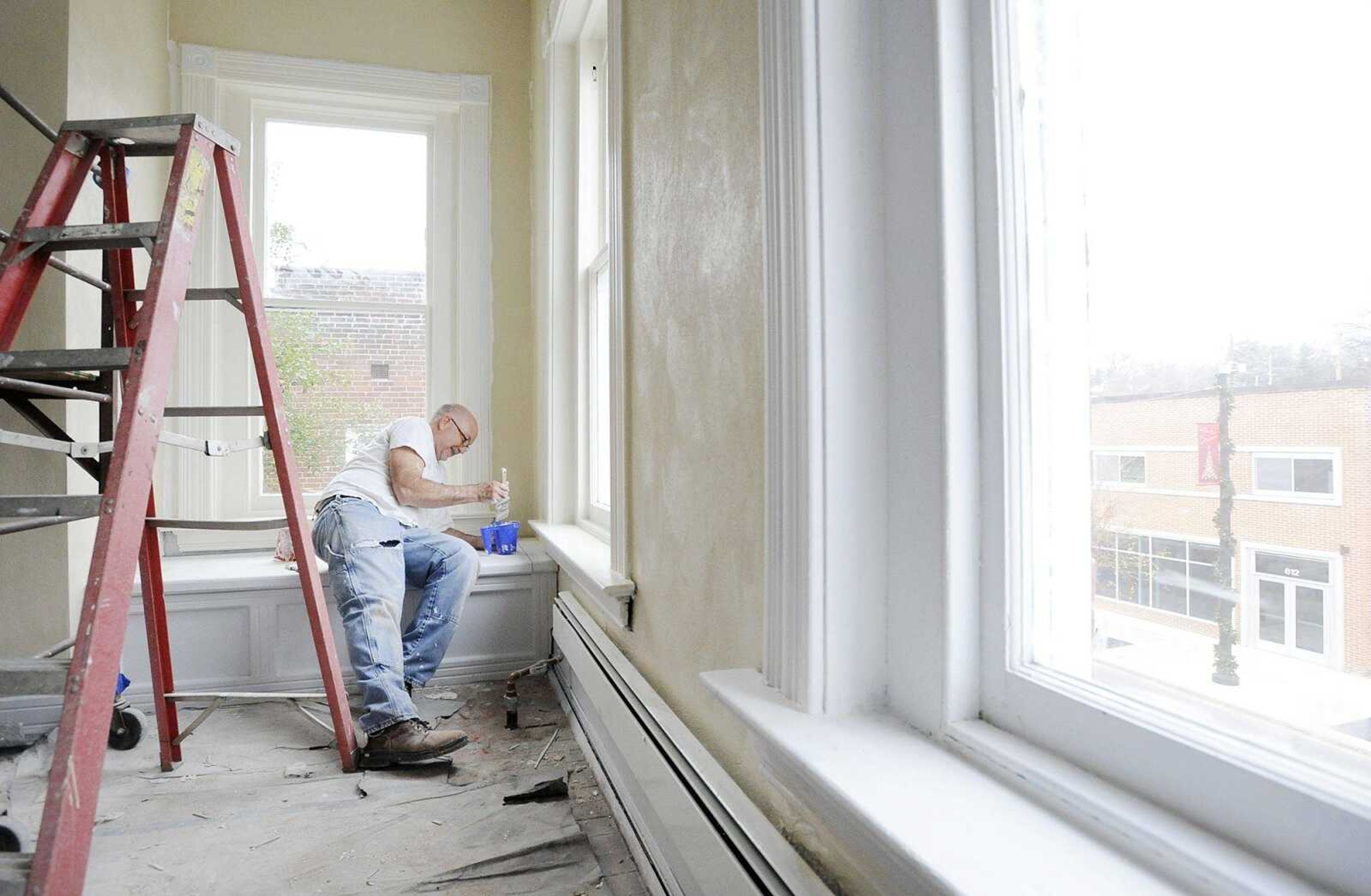 Alan Koeppel adds a fresh coat of paint to a wall on the second floor of the Indie House, Monday, Dec. 7, 2015, in Cape Girardeau. (Laura Simon)