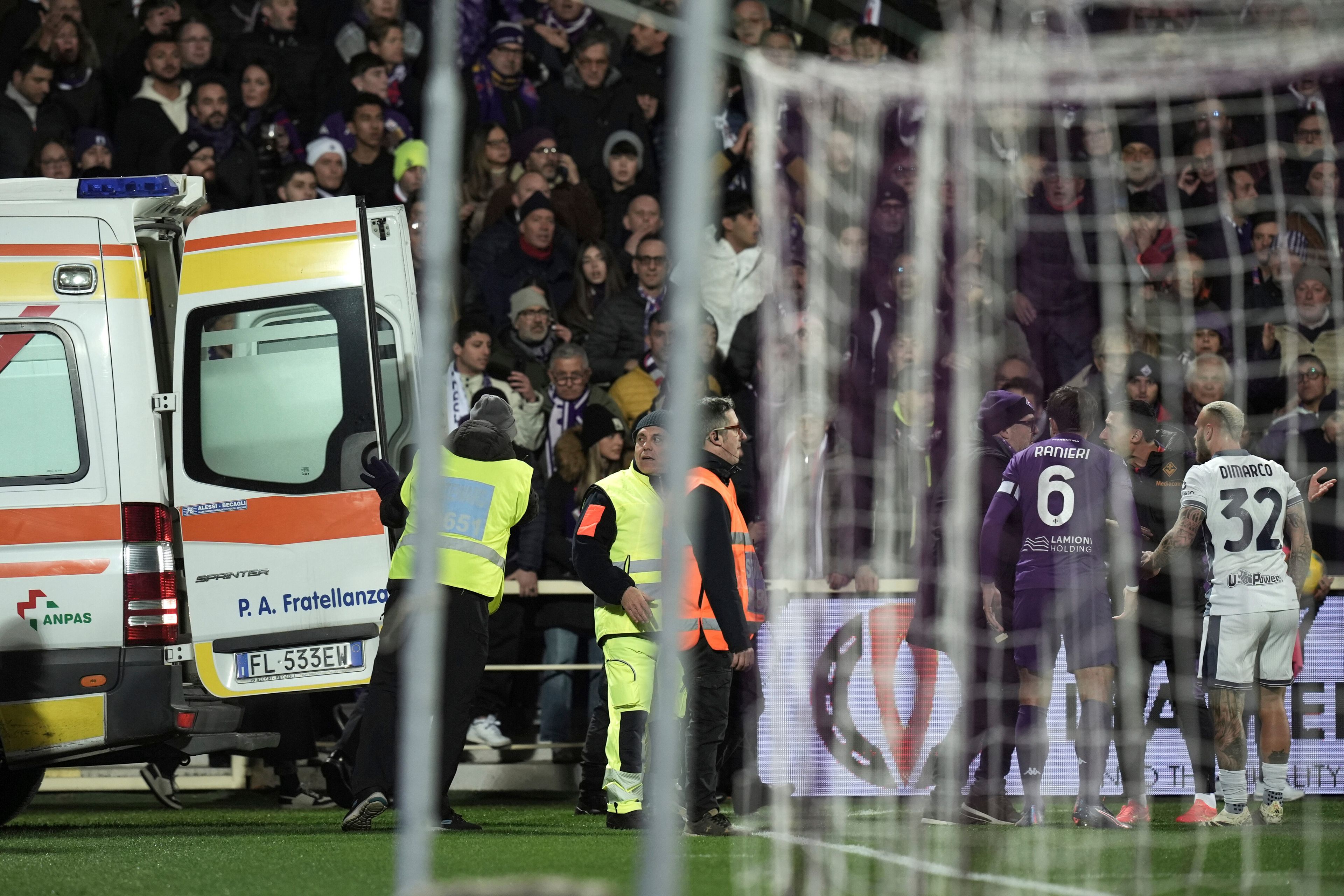 An ambulance enters the field as Fiorentina's Edoardo Bove, injured, is surrounded by players during the Serie A soccer match between Fiorentina and Inter at the Artemio Franchi Stadium in Florence, Italy, Sunday Dec. 1, 2024. The match was suspended and finally postponed as the injures appeared to be serious. (Massimo Paolone/LaPresse via AP)