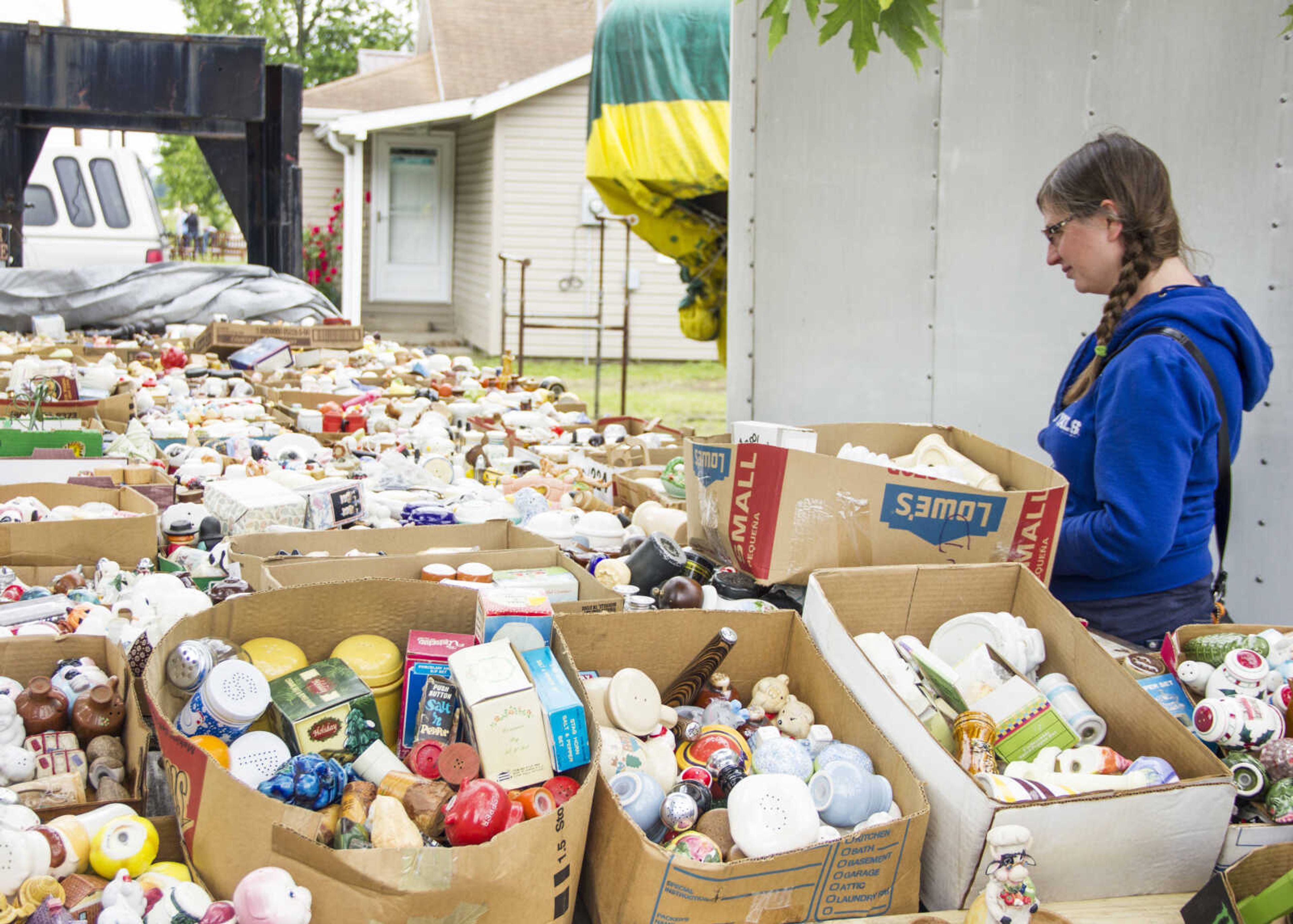 CAROL KELLISON ~ photo@semissourian.com

Gwena Basinger looks over a large collection of salt and pepper shakers at the 100-mile yard sale on Thursday May 22, 2015 in Delta, Missouri.