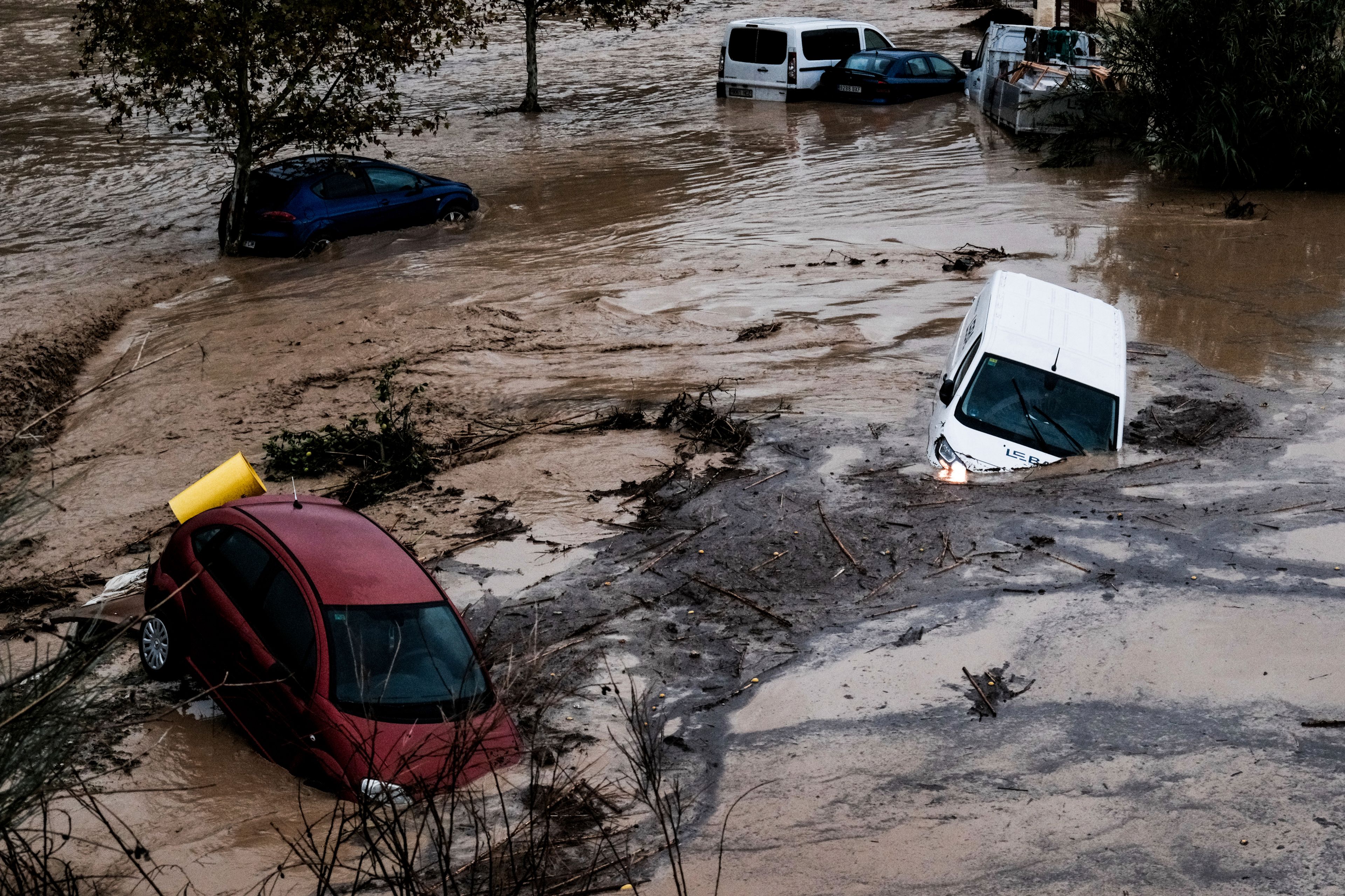 Cars are being swept away by the water, after floods preceded by heavy rains caused the river to overflow its banks in the town of Alora, Malaga, Spain, Tuesday, Oct. 29, 2024. (AP Photo/Gregorio Marrero)