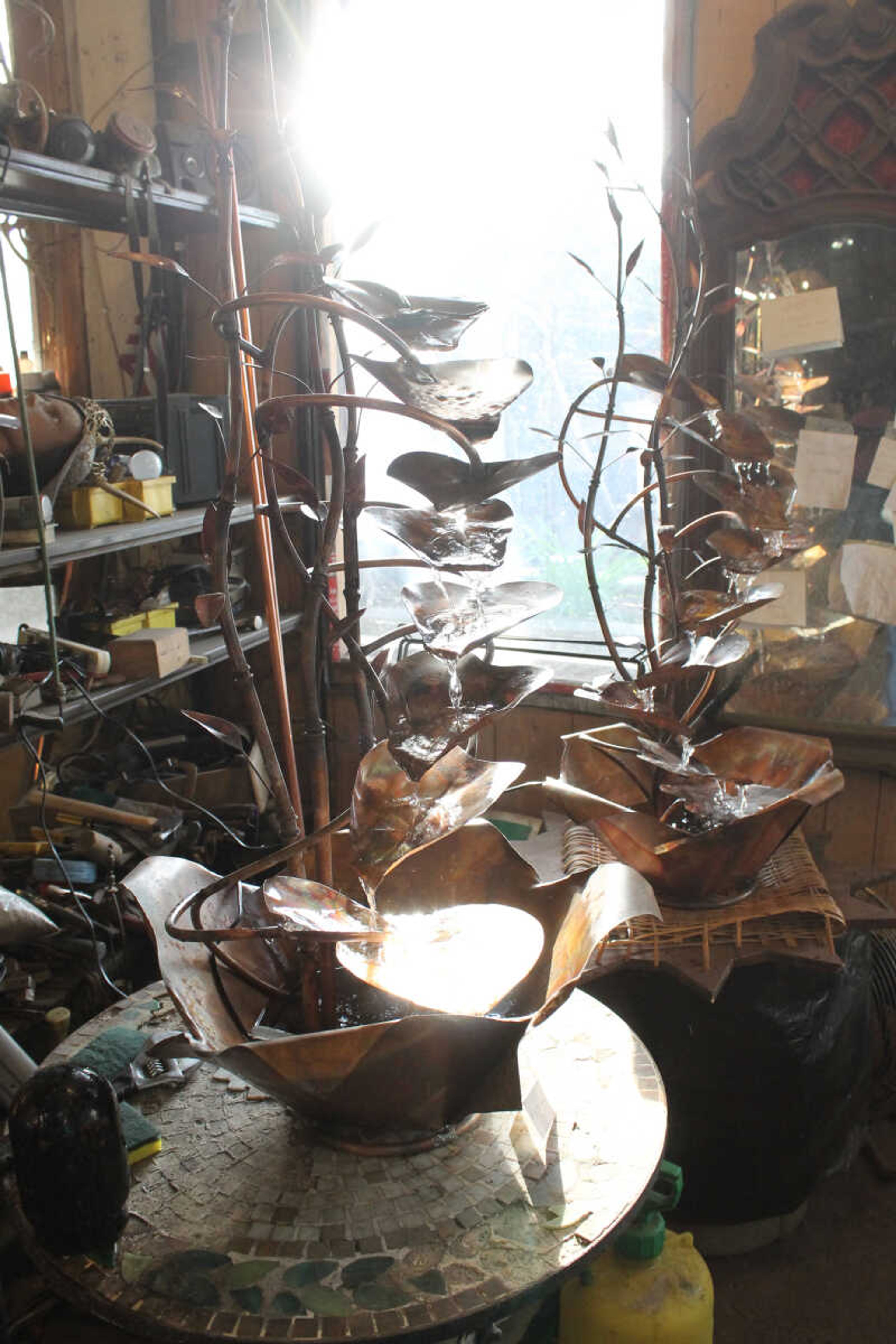 Emily Priddy ~ epriddy@semissourian.com
Sunlight pours in a front window, illuminating a pair of metal fountains Friday, March 10, 2017, at Rainmaker Studio in Makanda, Illinois.