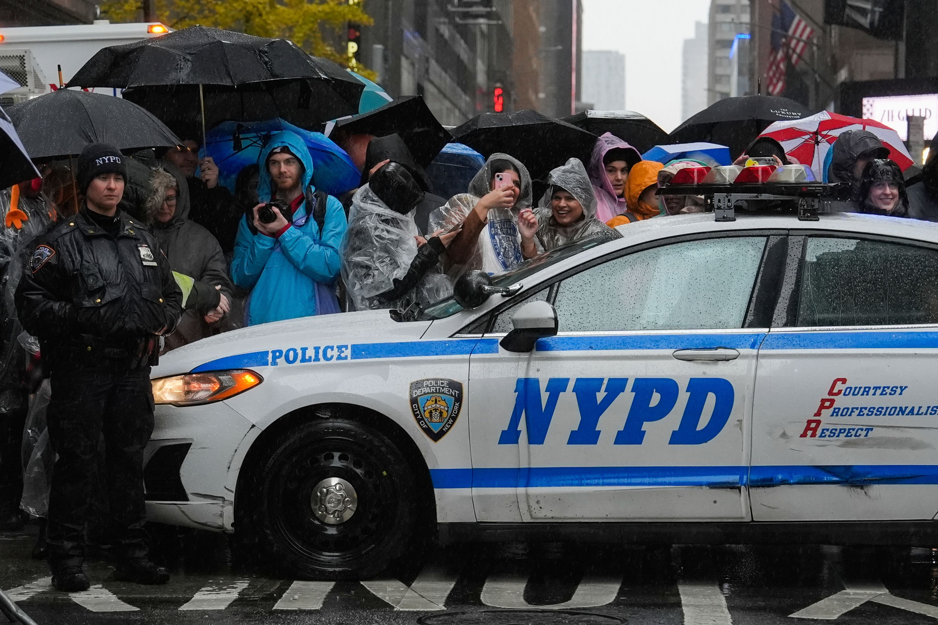 Spectators watch the Macy's Thanksgiving Day Parade on Sixth Avenue, Thursday, Nov. 28, 2024, in New York. (AP Photo/Julia Demaree Nikhinson)