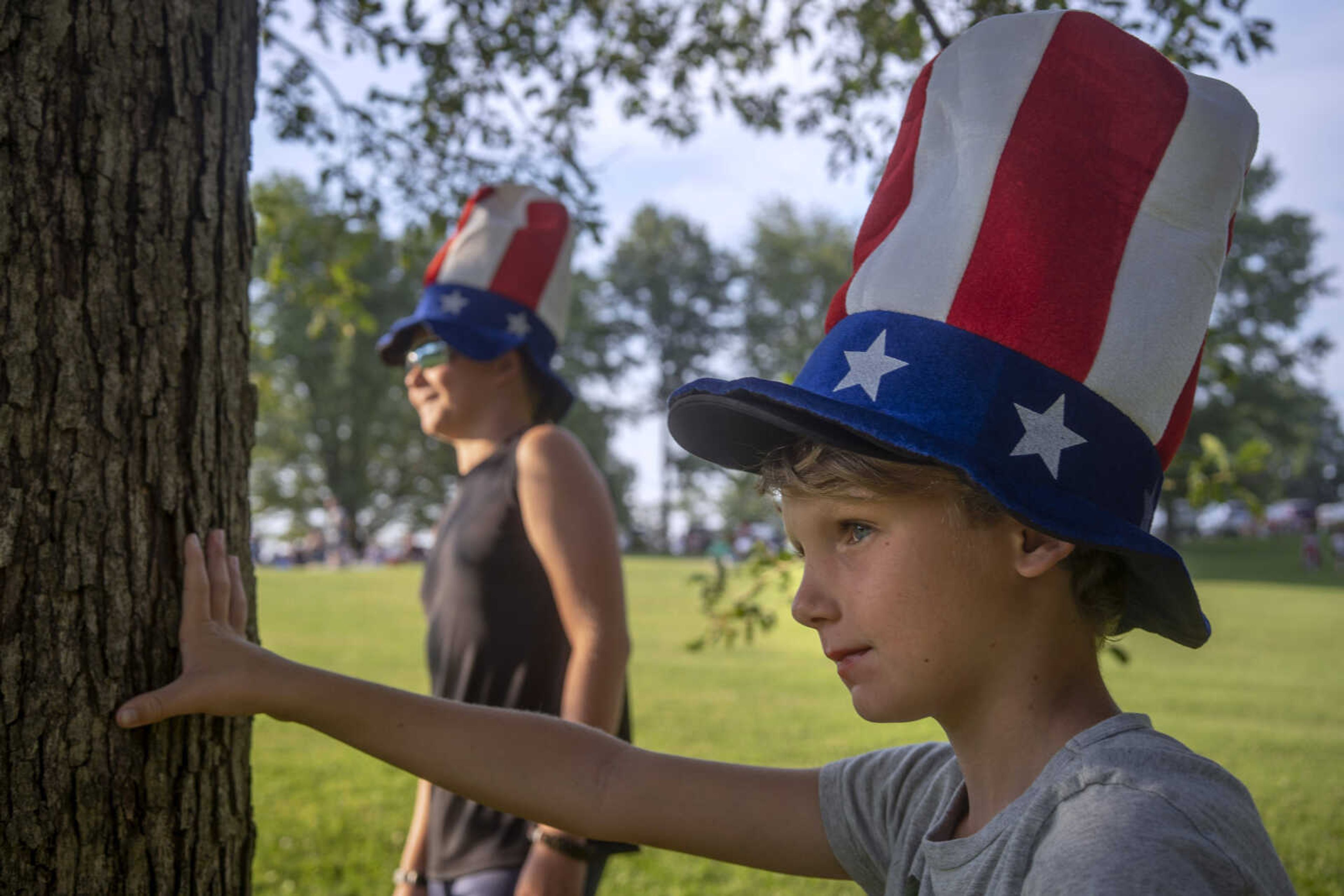 Bryce Fullhart, 9, right, and his brother, Wade, 11, wear matching patriotic hats while watching Shades of Soul play at the Jackson Municipal Band Shell during an Independence Day celebration.