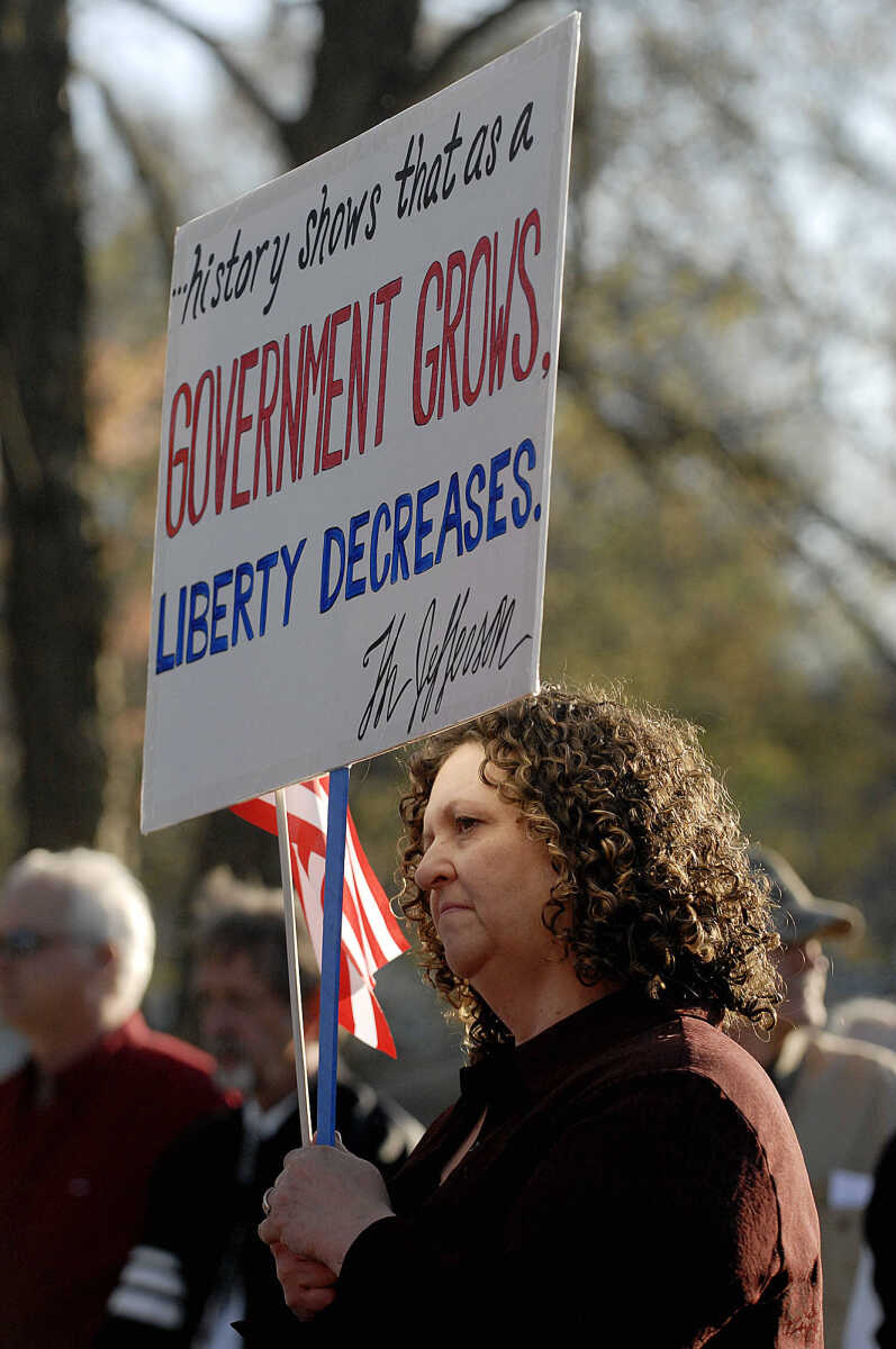 ELIZABETH DODD ~ edodd@semissourian.com
Christy Scott of Altenburg listens to speakers at a "tea party" tax protest at Capaha Park with a crowd of about 600 people April 15.