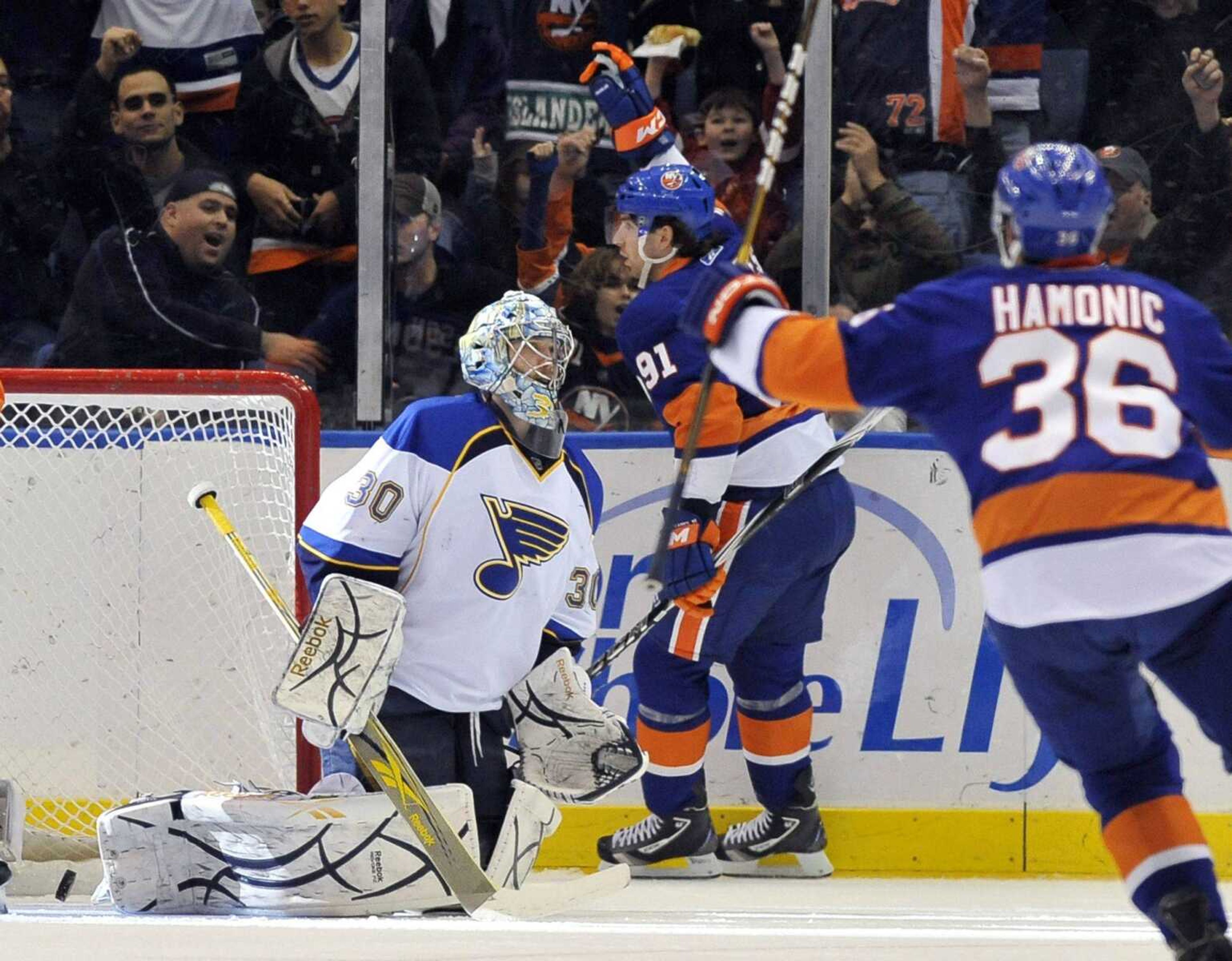 Islanders forward John Tavares and defenseman Travis Hamonic celebrate Tavares' goal as Blues goalie Ben Bishop reacts during the first period Saturday in Uniondale, N.Y. (KATHY KMONICEK ~ Associated Press)