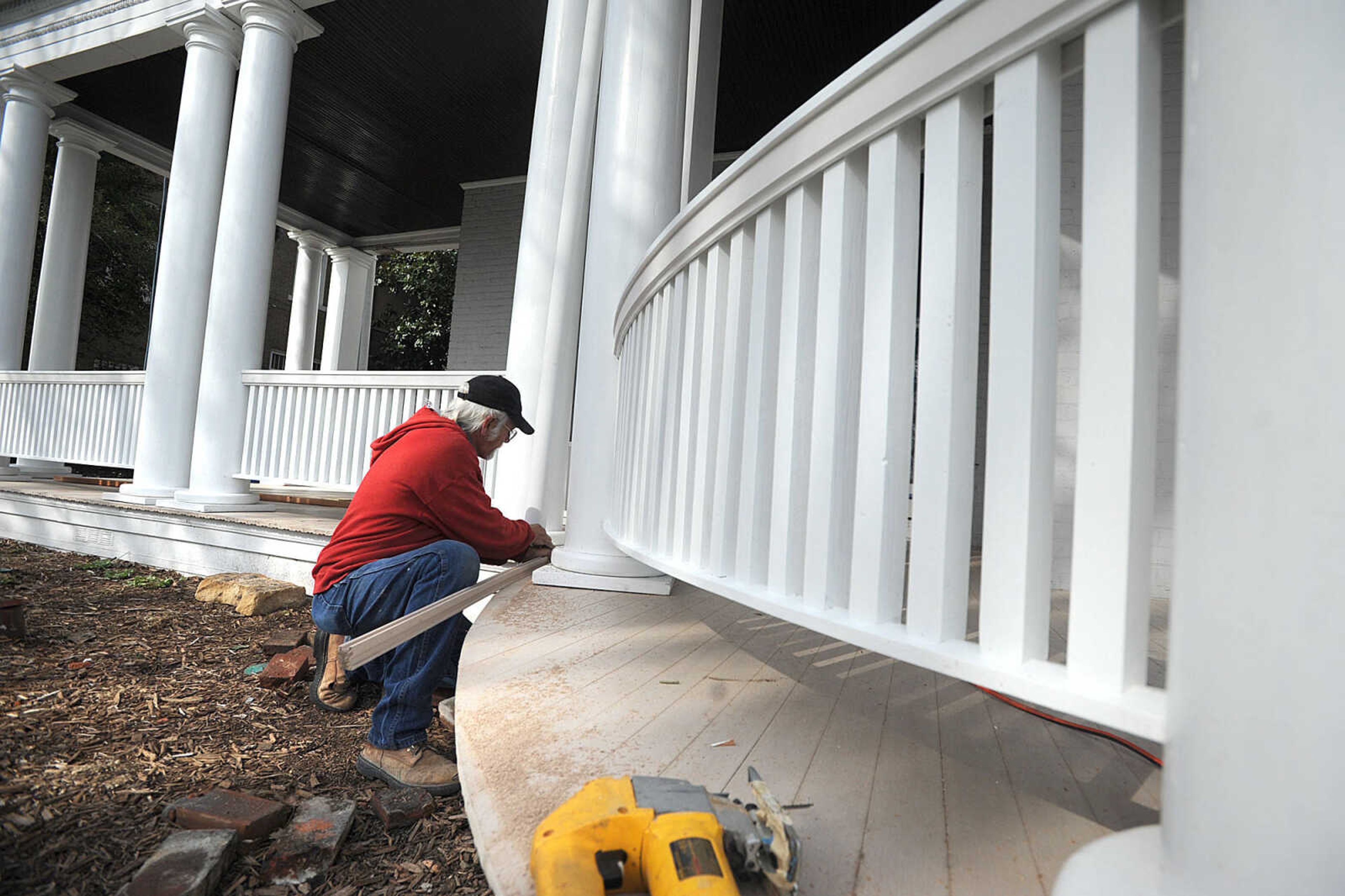 LAURA SIMON ~ lsimon@semissourian.com
Mike VanHouten with Brock Milam Masonry works on the trim of the front porch of the Glenn House Friday morning, March 15, 2013 in Cape Girardeau. The railing on the balcony and front porch have been replaced using cedar, and the floor of the front porch has been replaced with composite. The bases of the porch columns have been repaired, leaving them in near original condition.