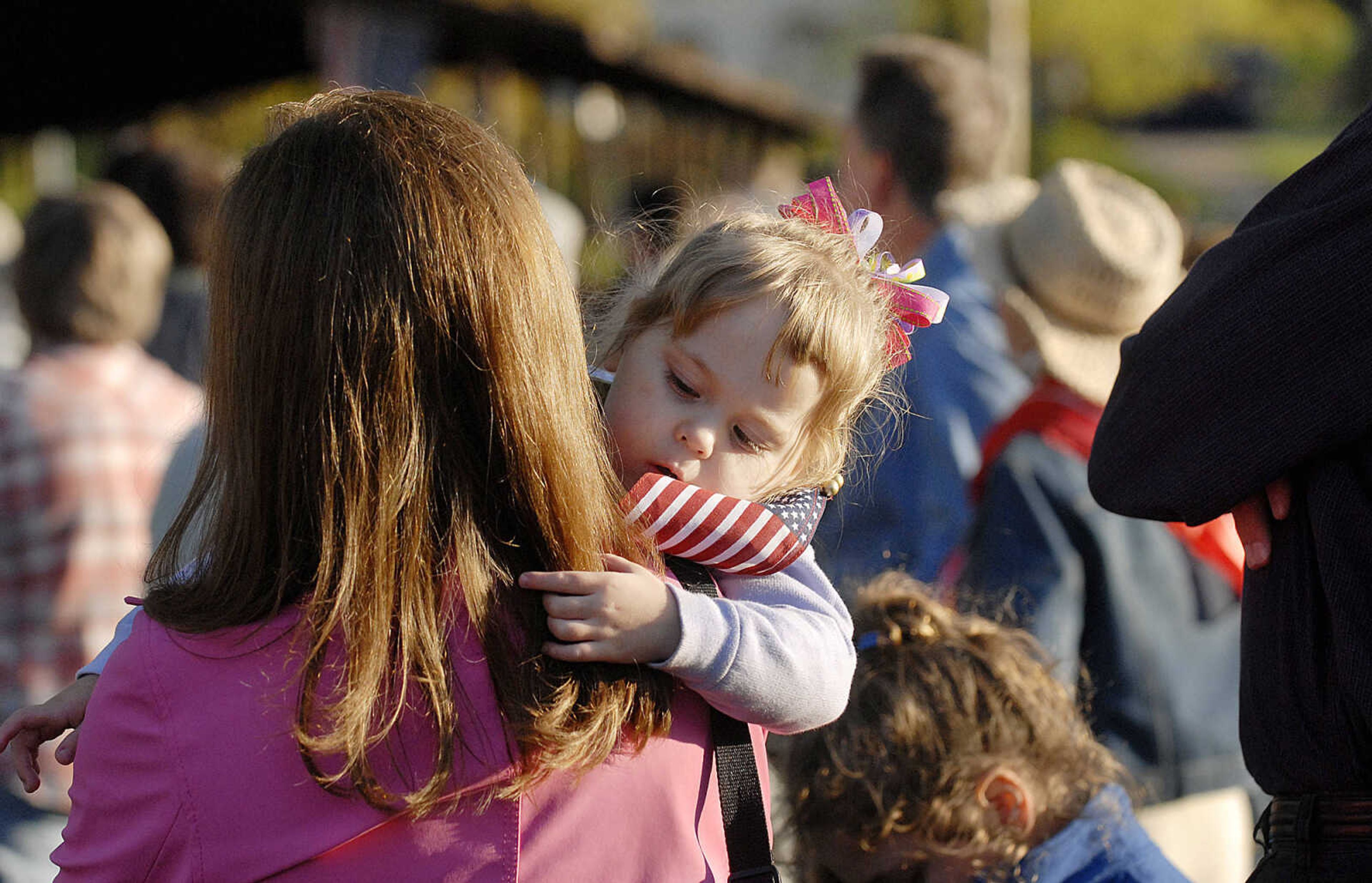 ELIZABETH DODD ~ edodd@semissourian.com
Abigail Hutson, 3, plays with her mother Melody's hair as she listens to speakers at a "tea party" tax protest at Capaha Park Wednesday.