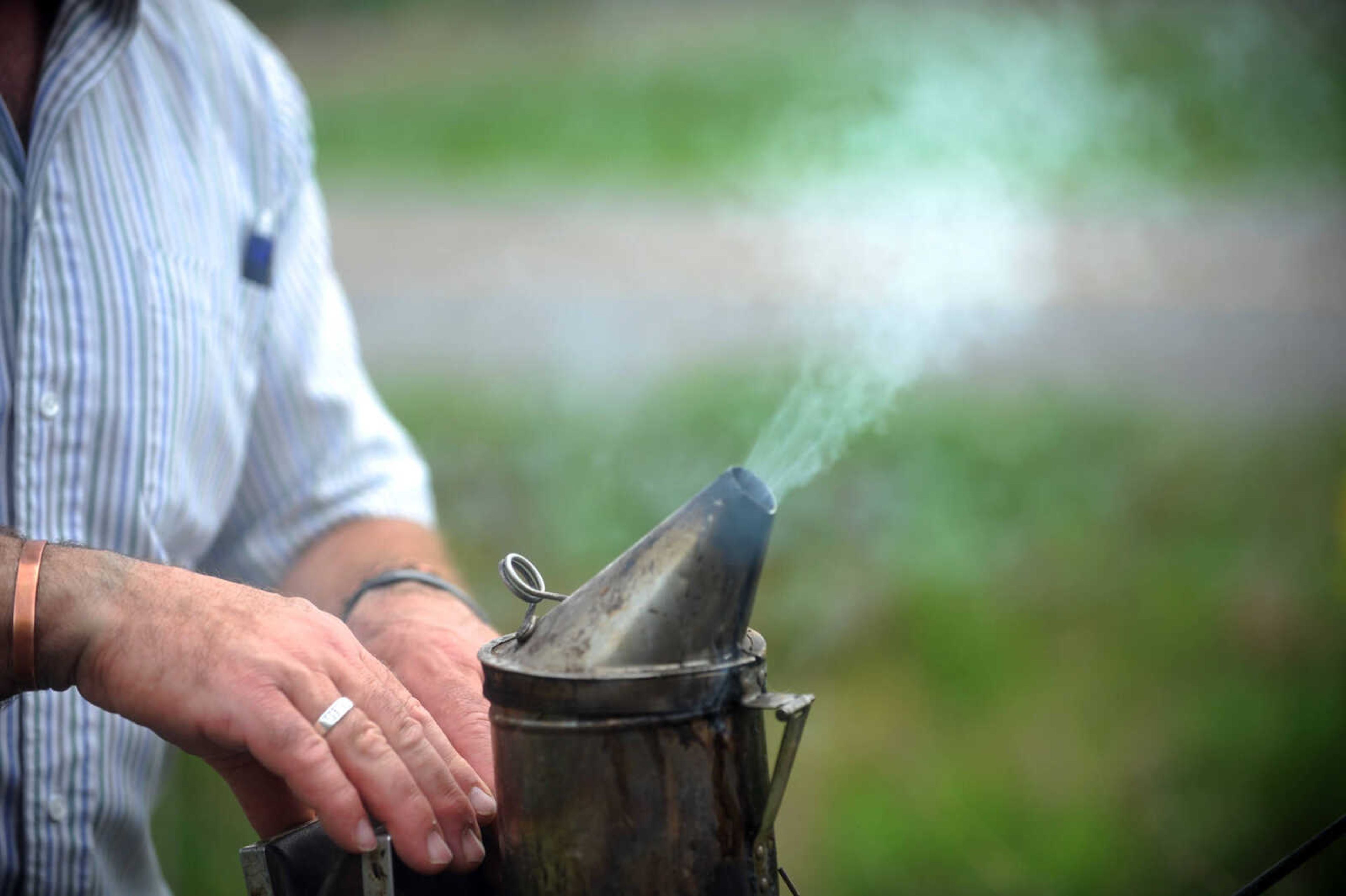 LAURA SIMON ~ lsimon@semissourian.com

Grant Gilliard checks on his beehives in Cape Girardeau County.