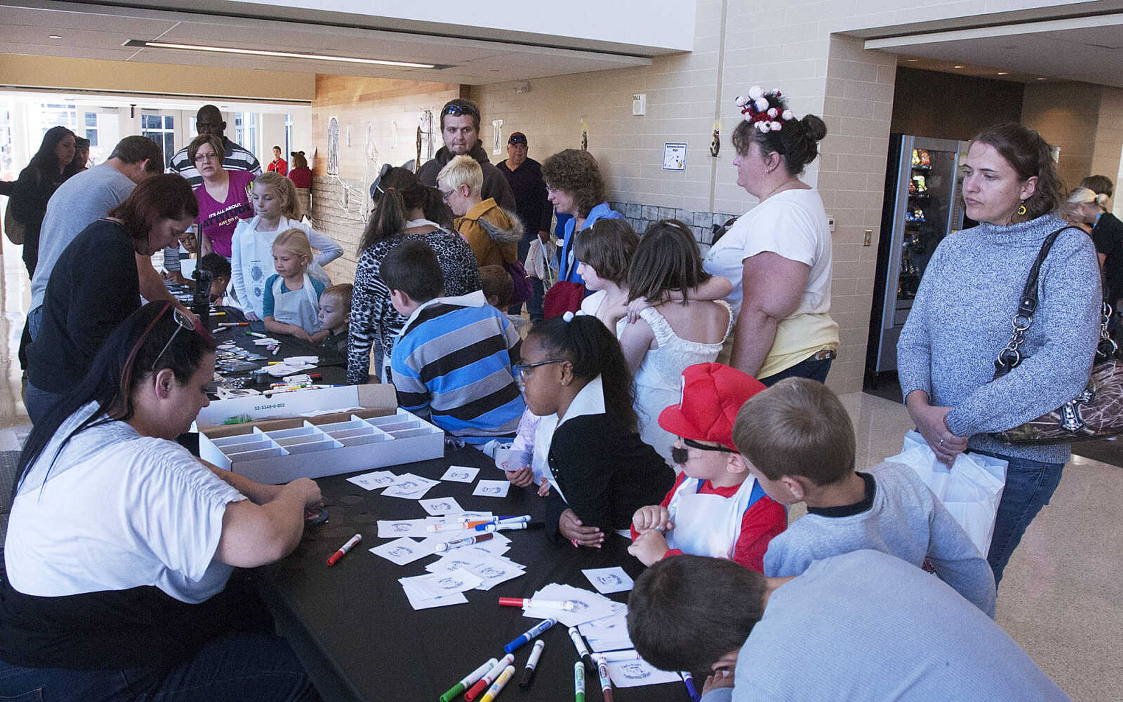 Children line up to make buttons during the fifth annual Halloween Science Night Sunday, Oct. 20, on the campus of Southeast Missouri State University. The event featured 21 stations, such as the "Scream Room," "Creepy Creatures," or the "Mucus Lab," each with a different Halloween themed science activity. The night is funded by a grant from the Missouri Foundation for Health in partnership with Southeast's College of Science, Technology and Agriculture and Extended and Continuing Education.