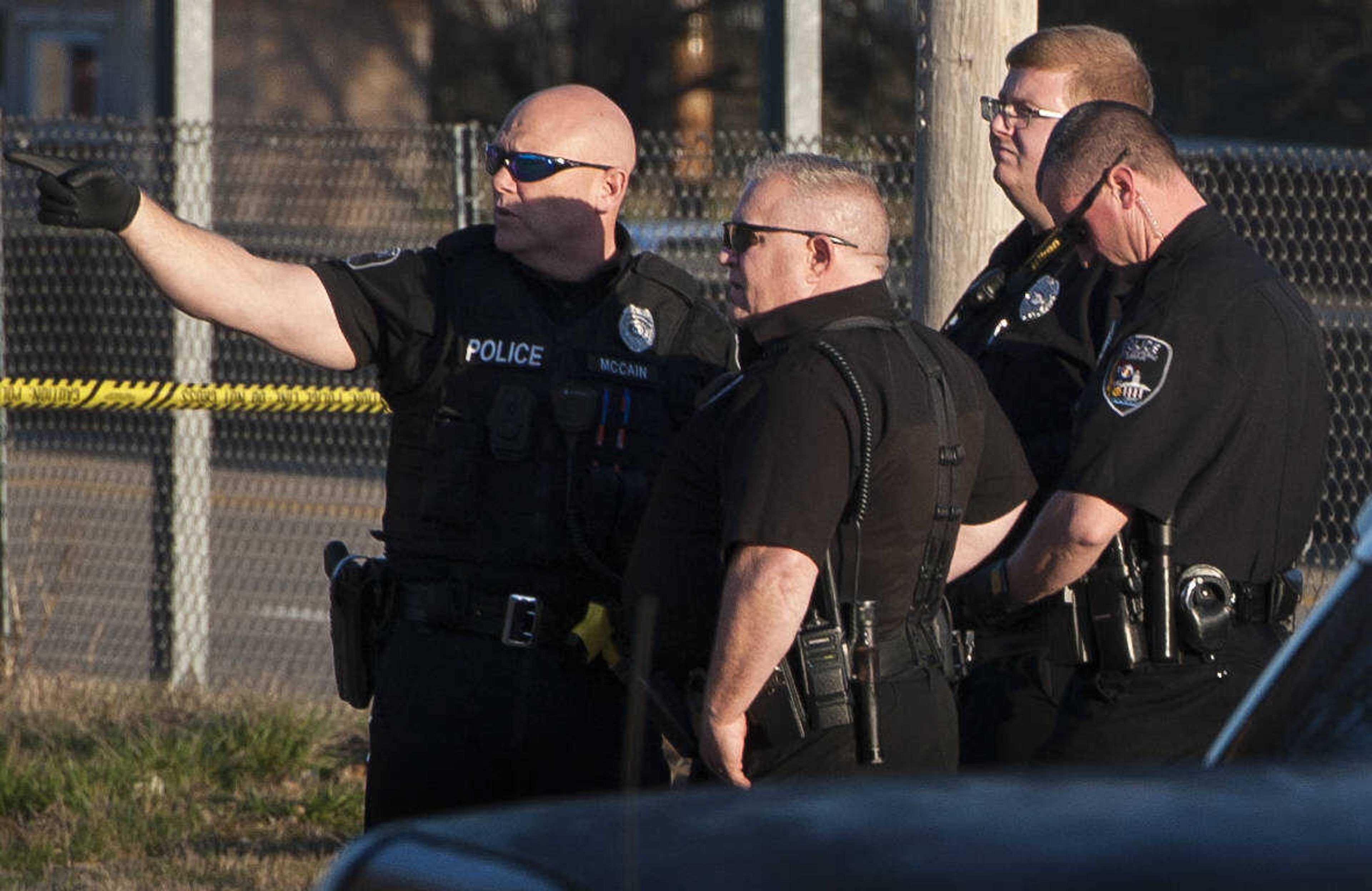 Cape Girardeau police officers convene while investigating the scene of a shooting at 918 College Street on Tuesday, March 3, 2020, in Cape Girardeau.