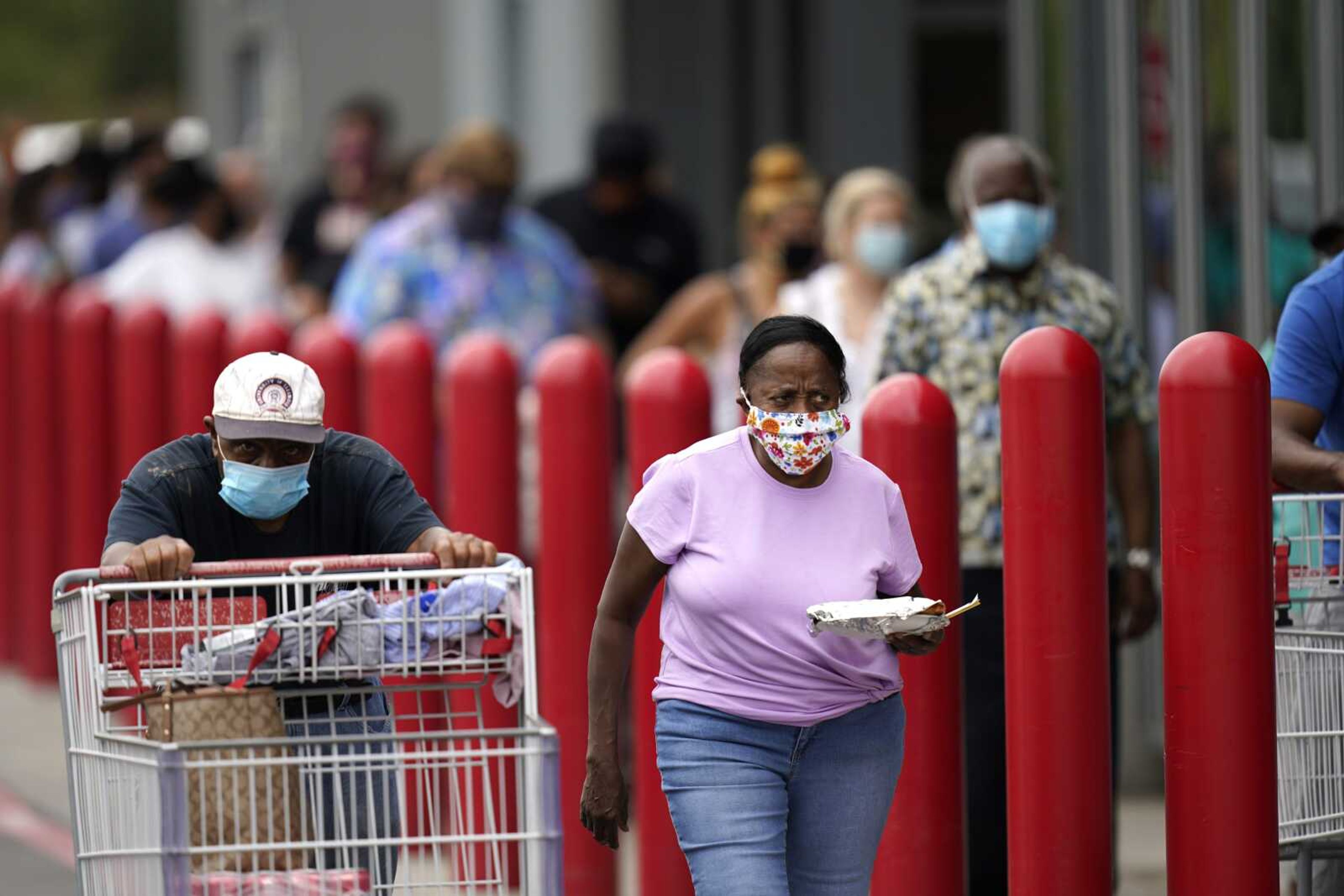 People line up to enter retail chain Costco to buy provisions Sunday in New Orleans in advance of Hurricane Marco, expected to make landfall on the Southern Louisiana coast.