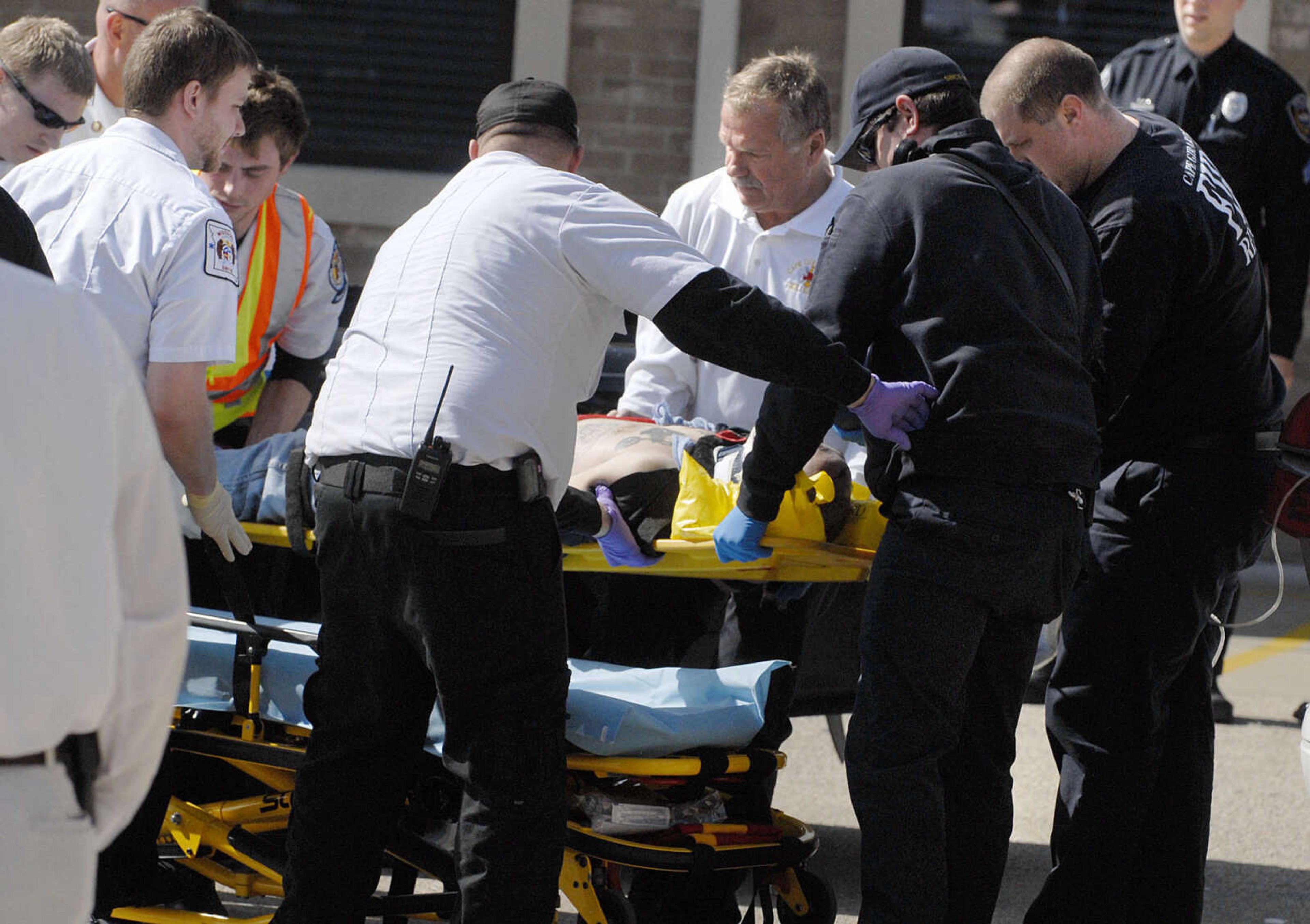 LAURA SIMON ~ lsimon@semissourian.com
Cape Girardeau emergency responders work on a victim of a self-inflicted gun shot wound outside Dan's Key and Lock Tuesday afternoon, March 6, 2012. Police say the man is a suspect in a Sunday assault along Cape LaCroix Recreational Trail.