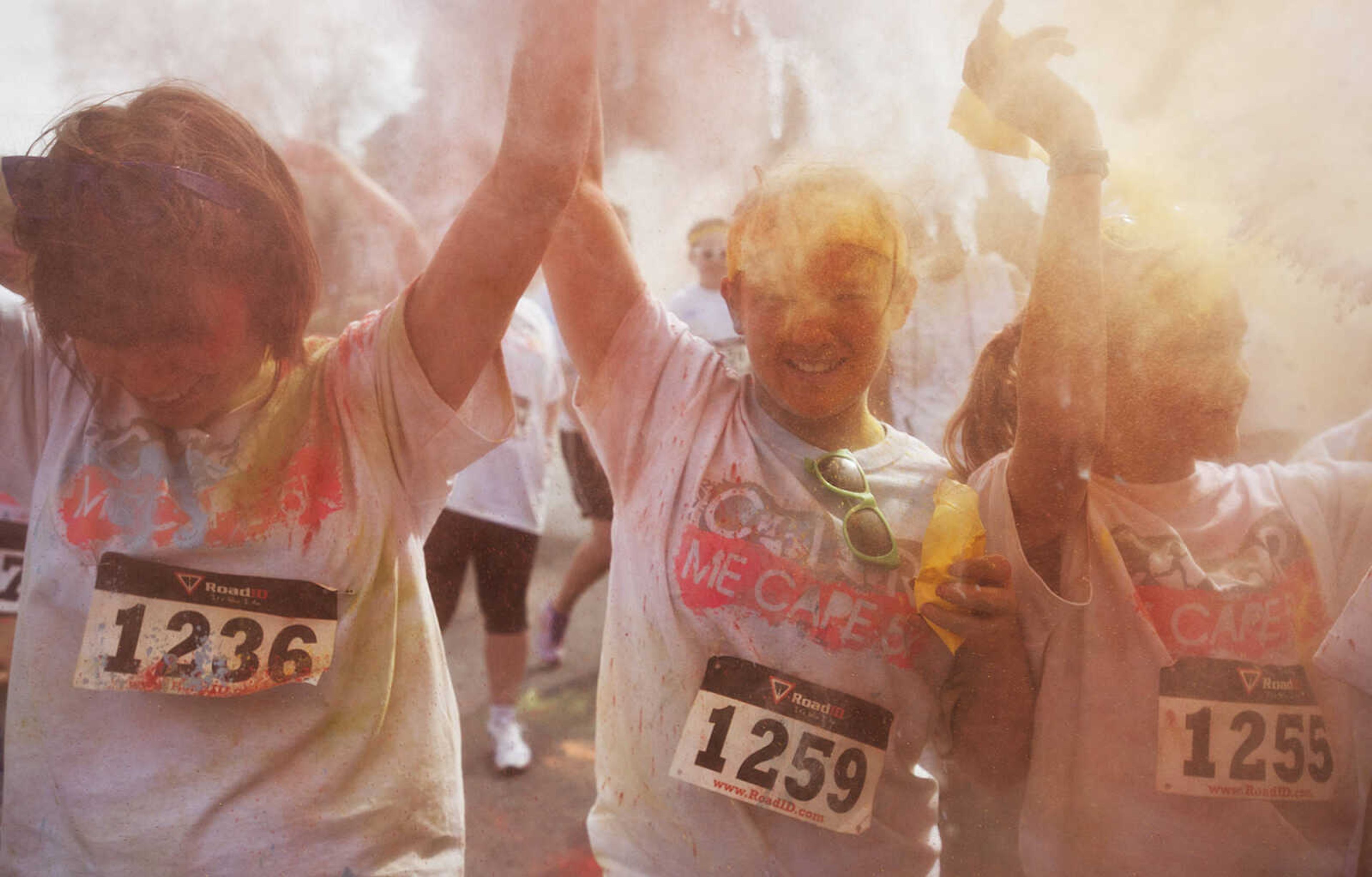 ADAM VOGLER ~ avogler@semissourian.com
Participants in the Color Me Cape 5k throw colored powder in the air in the street in front of the Bell Air Grill during the color bomb after the run Saturday, April 12, in Cape Girardeau.