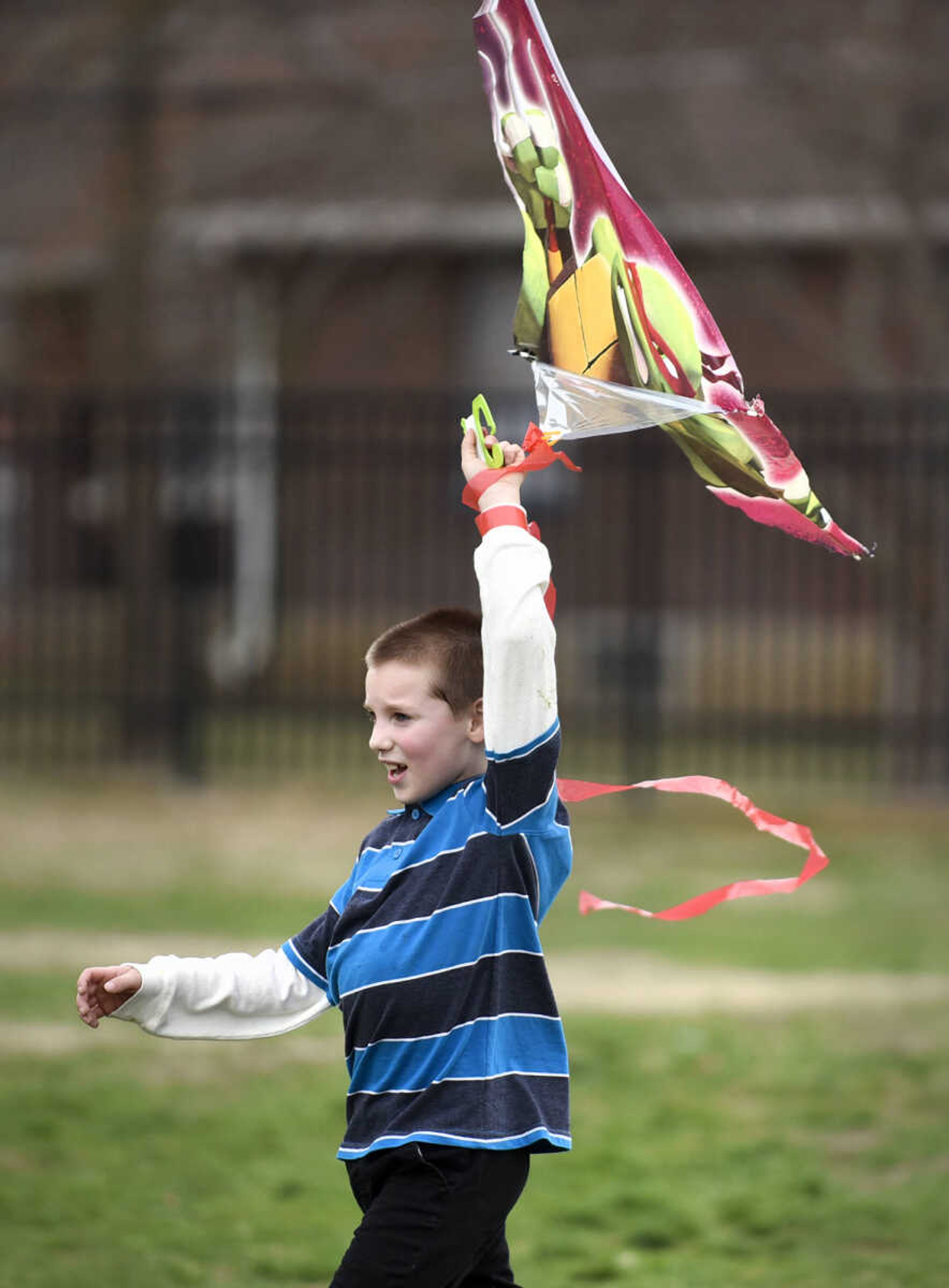 Colton Anglin carries his kite across the playground on Friday, Feb. 24, 2017, at Franklin Elementary in Cape Girardeau. Lyndora Hughes second grade class spent a portion of the afternoon flying their kites as part of their story celebration for reading "Gloria Who Might Be My Best Friend".