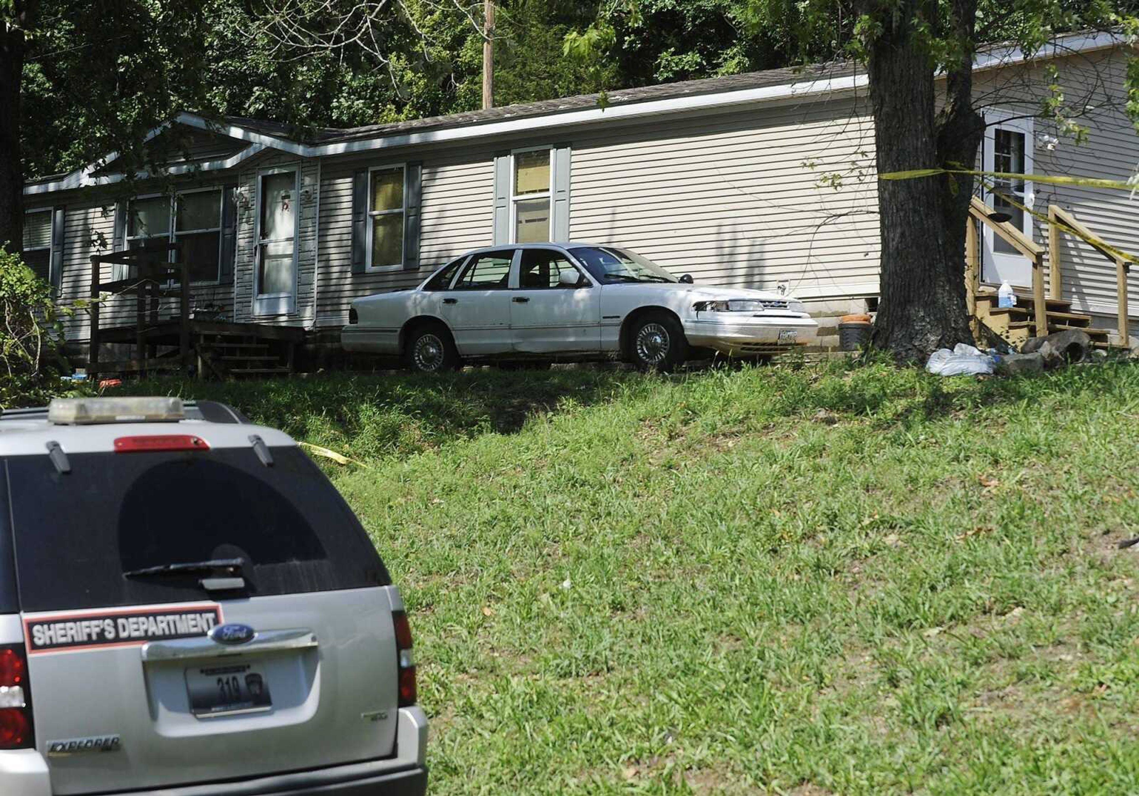 A house on County Road 834 in Bollinger County is blocked off by crime scene tape Friday, September 7, while the Cape Girardeau/Bollinger County Major Case Squad, is investigate the death of Jefferey Scott Robins after he was found dead in his rural Bollinger County home Thursday afternoon. (Adam Vogler)