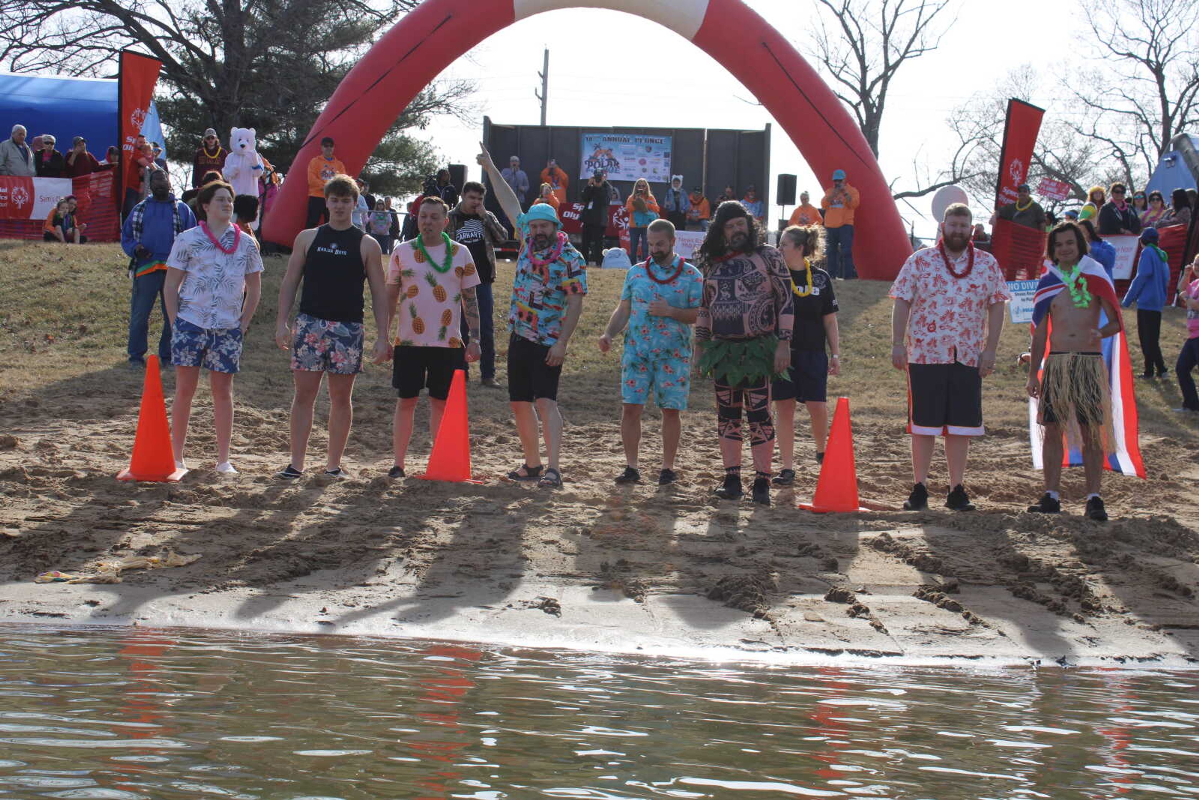 Polar Plunge team "Copsicles" take the plunge together.