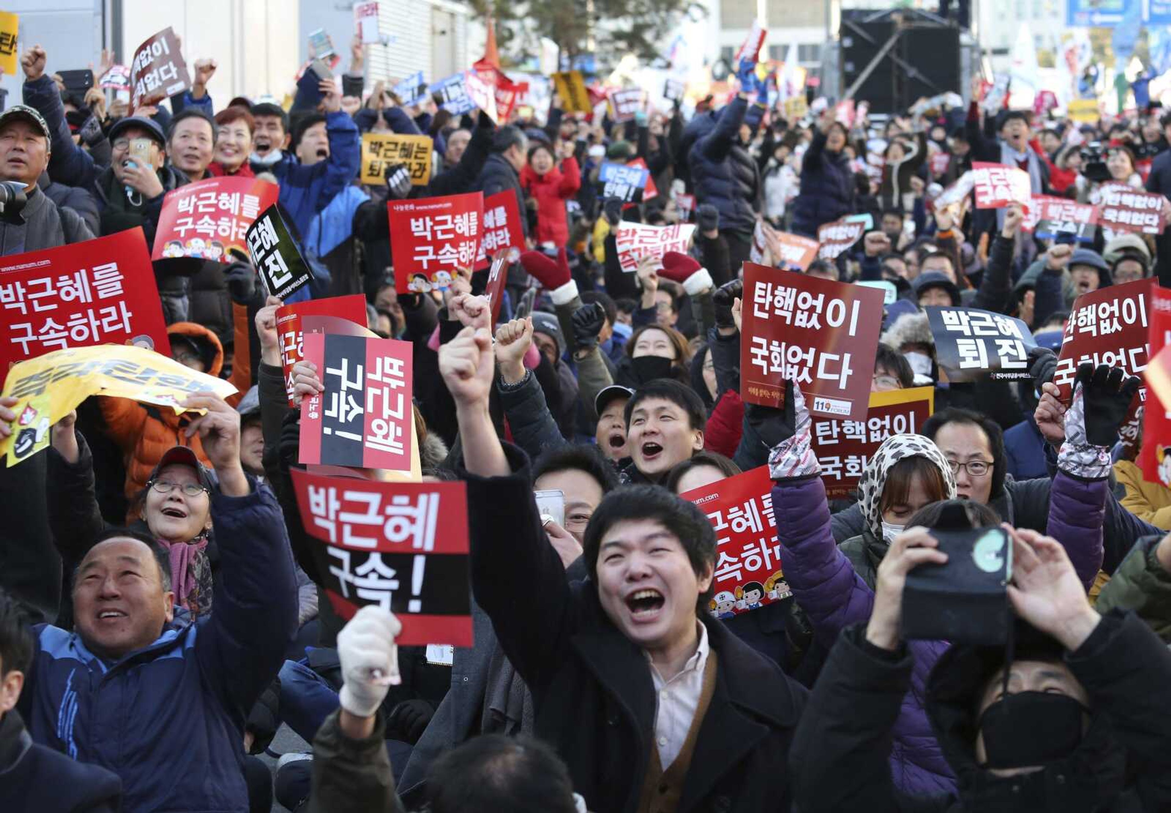 Protesters celebrate after hearing the news Friday of President Park Geun-hye's impeachment in front of the National Assembly in Seoul, South Korea.